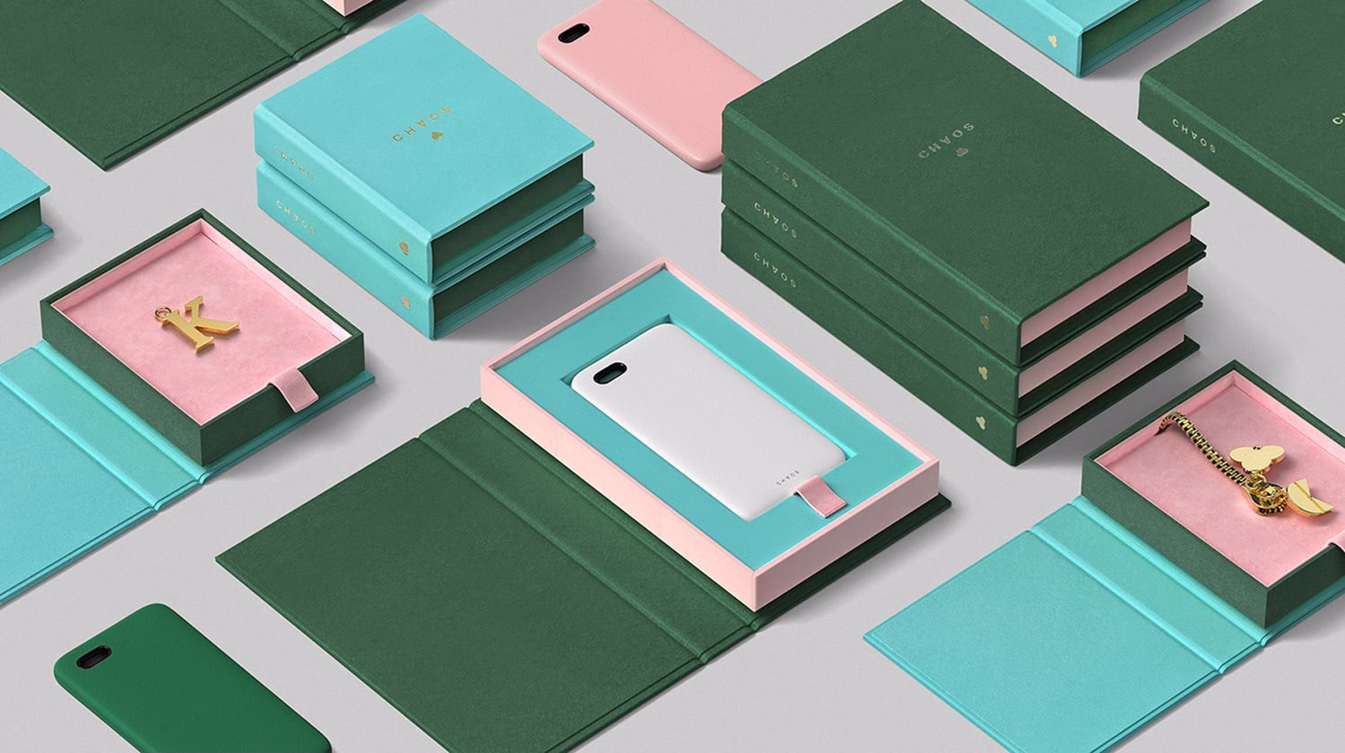 A flat lay of green and turquoise boxes and cases, featuring a white phone case and gold charm in pink-lined containers.