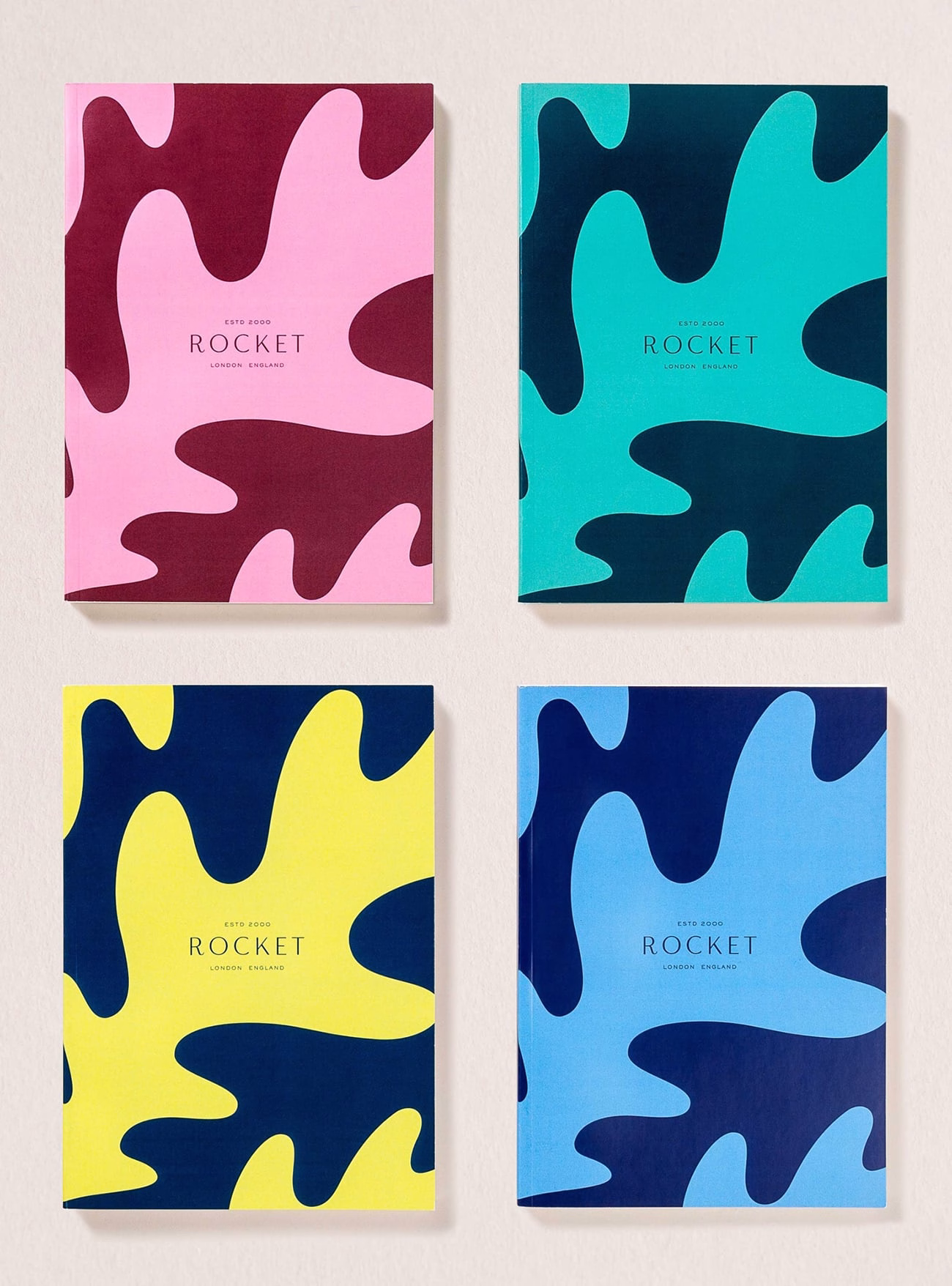 Four notebooks, each with colorful abstract shapes, feature titles in bold typography. Colors include pink, turquoise, yellow, and blue.