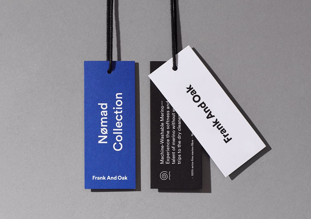 Three clothing tags in varying colors arranged on a gray background, showcasing minimalist typography.