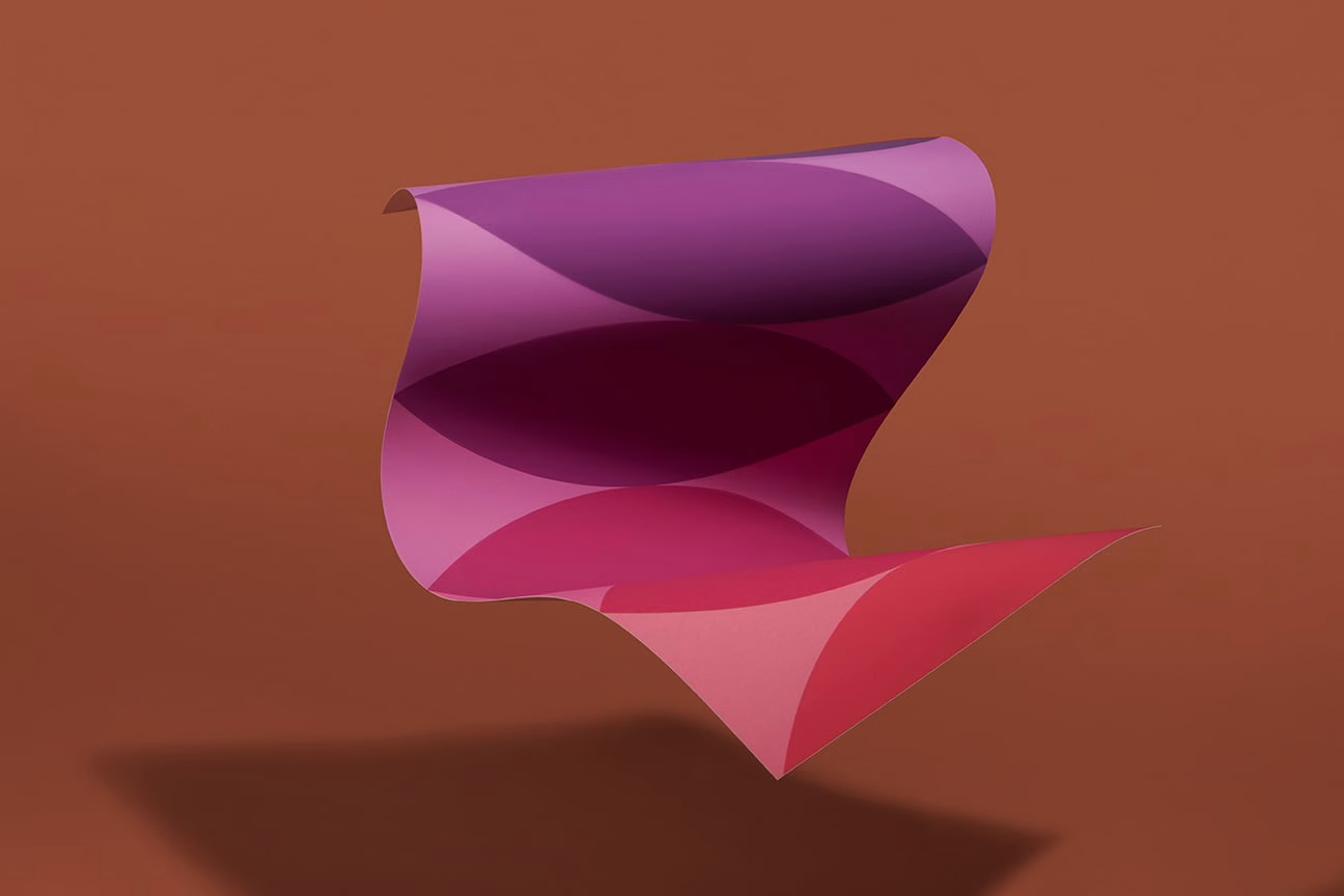 A flowing sheet of pink and purple forms curls against a muted brown background, creating a sense of movement.