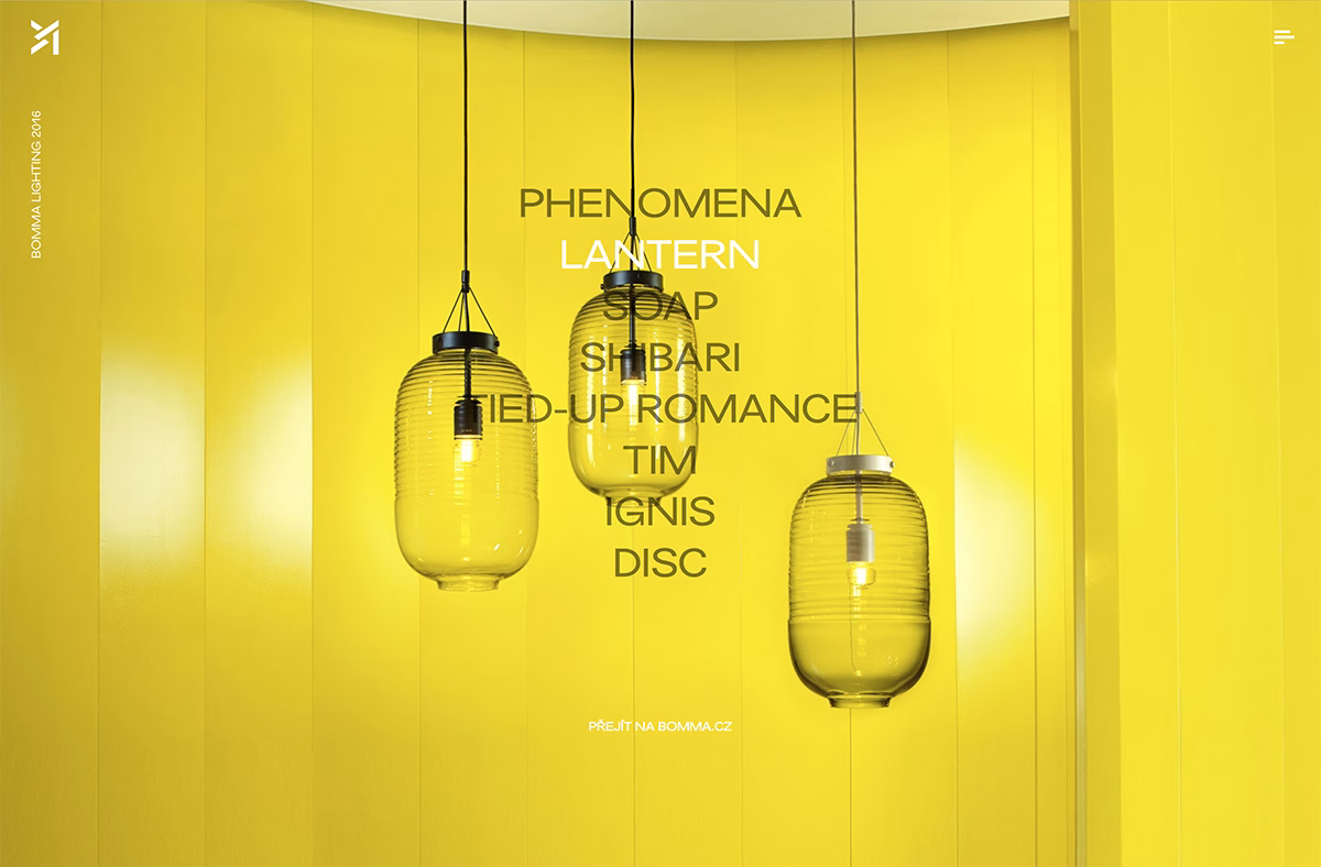 Three glass lanterns hang against a vibrant yellow wall, casting soft light in a minimalist setting.