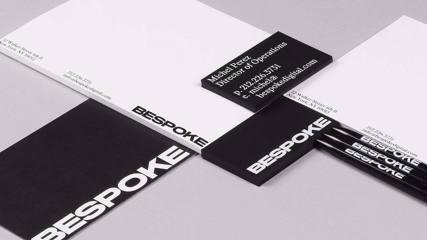 A collection of black and white stationery featuring the word "BESPOKE" in bold typography, arranged on a light surface.