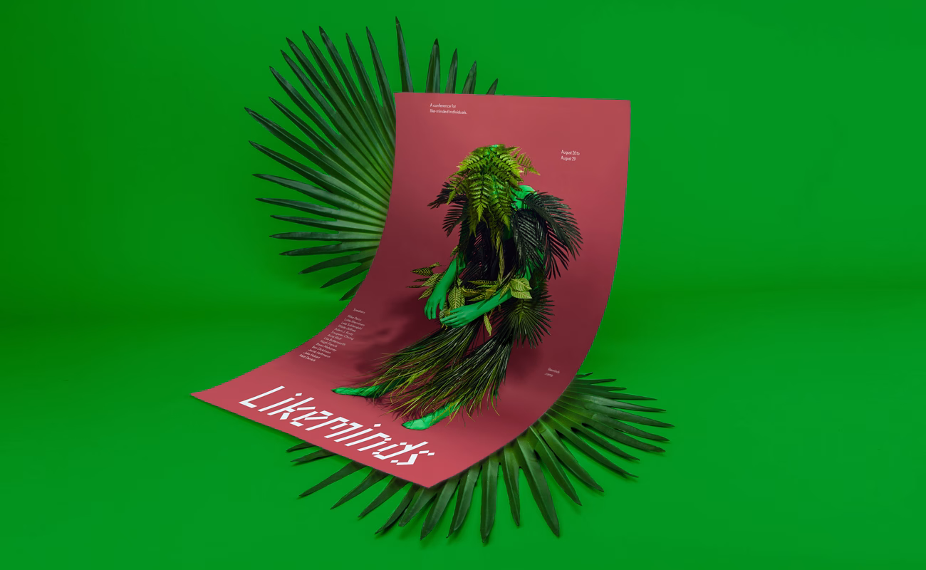 A coral poster featuring a figure made of foliage is set against a vibrant green background, surrounded by palm leaves.