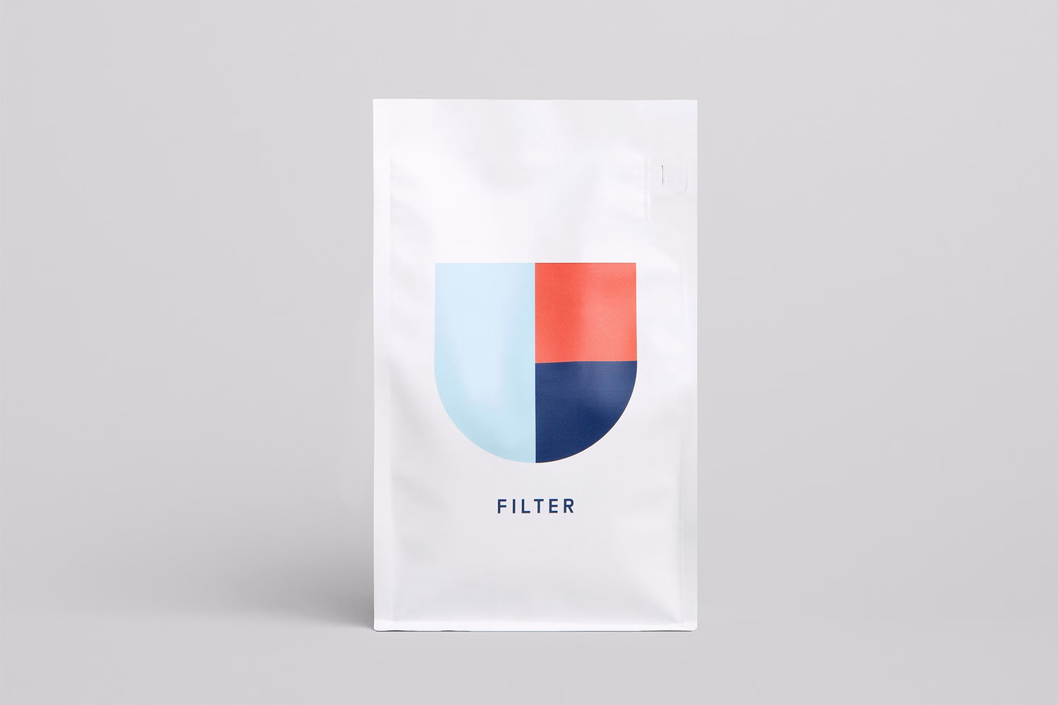 A white packaging bag featuring a minimalist graphic with light blue, red, and dark blue sections, labeled "FILTER."