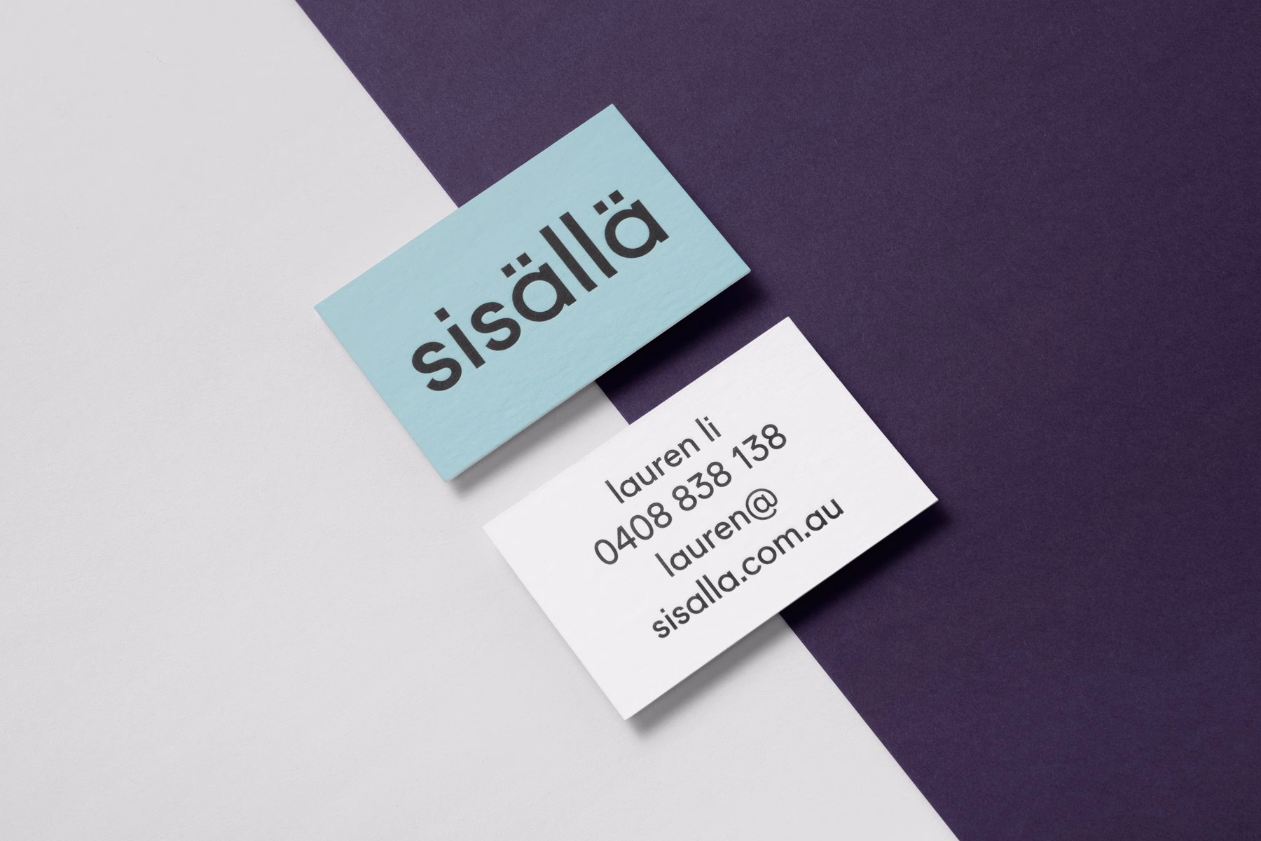 Two business cards are displayed on a divided background of white, deep purple, and light blue.