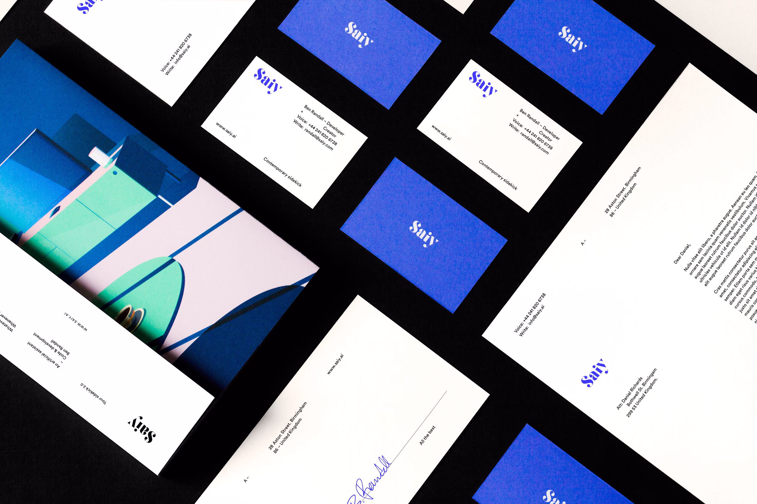 A collection of printed materials in black, white, and blue, featuring abstract designs and clean typography.