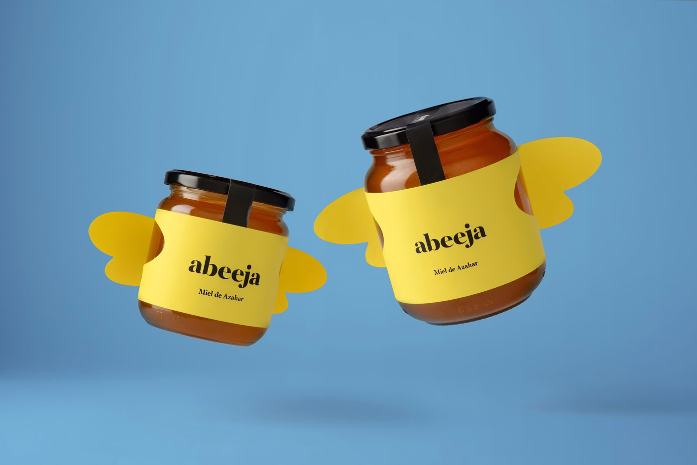 Two jars of honey with yellow labels and playful bee wing cutouts, floating against a light blue background.
