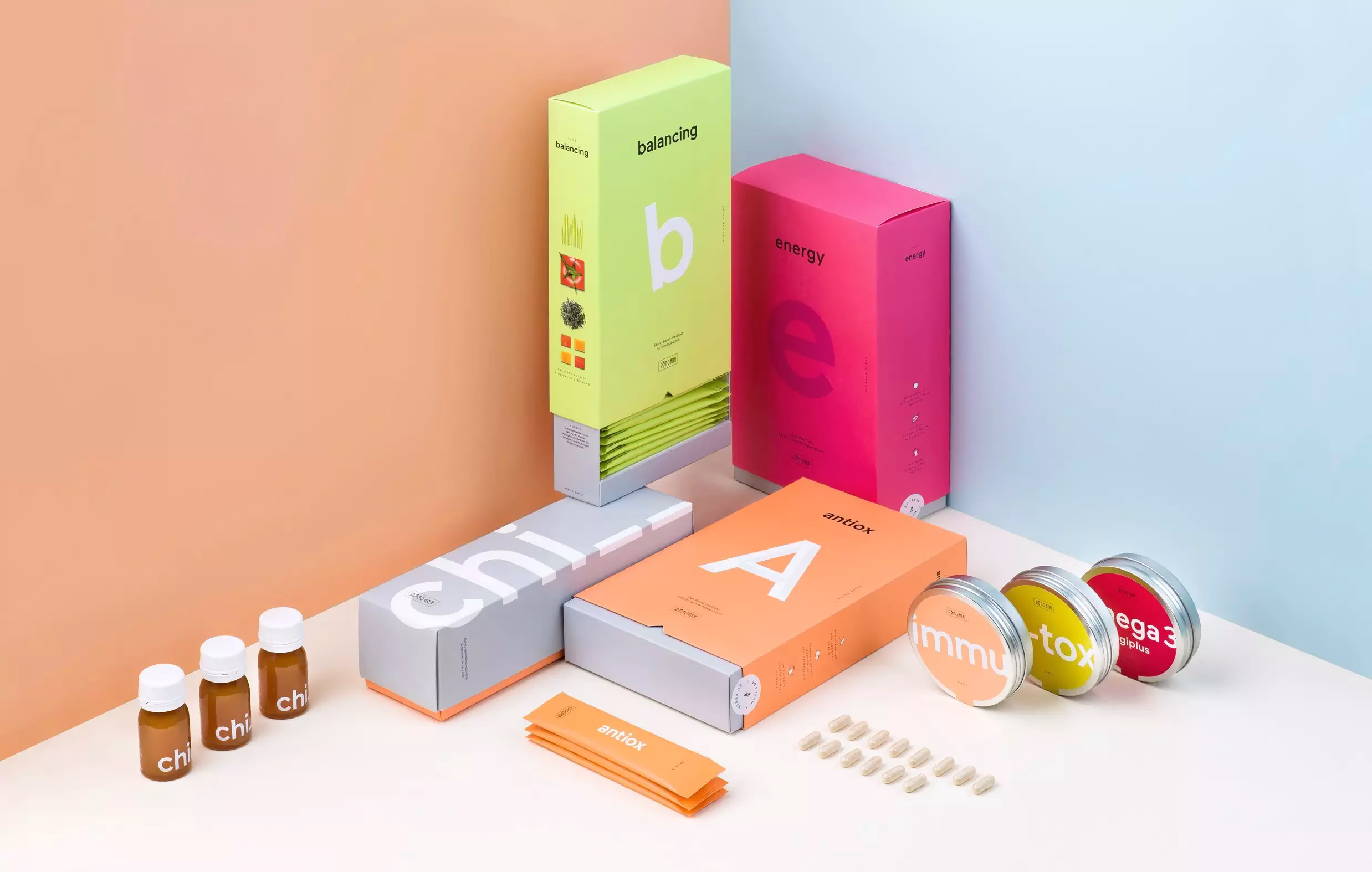 A collection of brightly colored health product boxes and supplements arranged aesthetically on a pale surface.