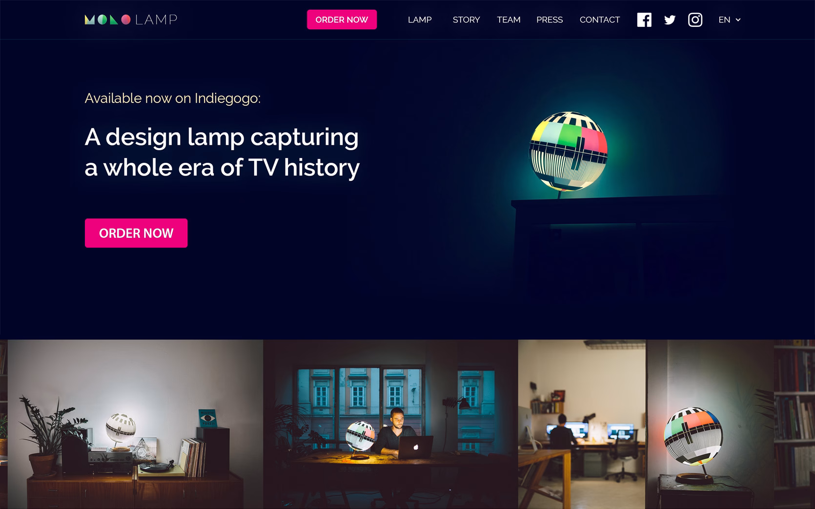 A colorful design lamp sits on a table, illuminating a dark room, with a man working at a laptop nearby.