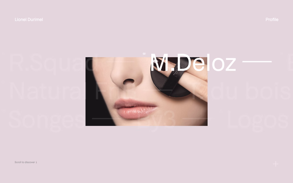 A close-up of a woman's face, softly lit, with a hand applying a black cosmetic product.