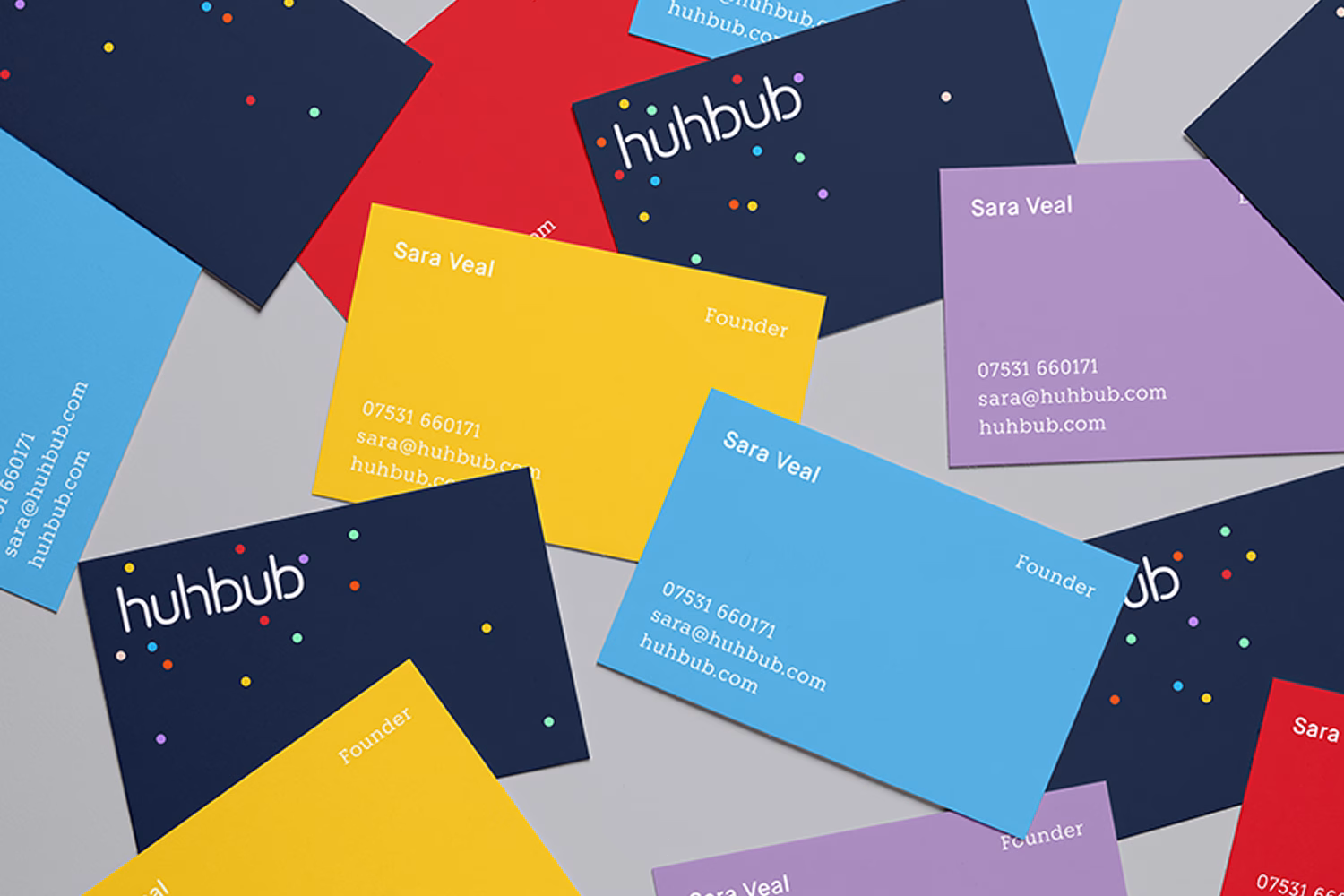 A collection of colorful business cards featuring the name "Sara Veal" and the brand "huhub" against a neutral background.