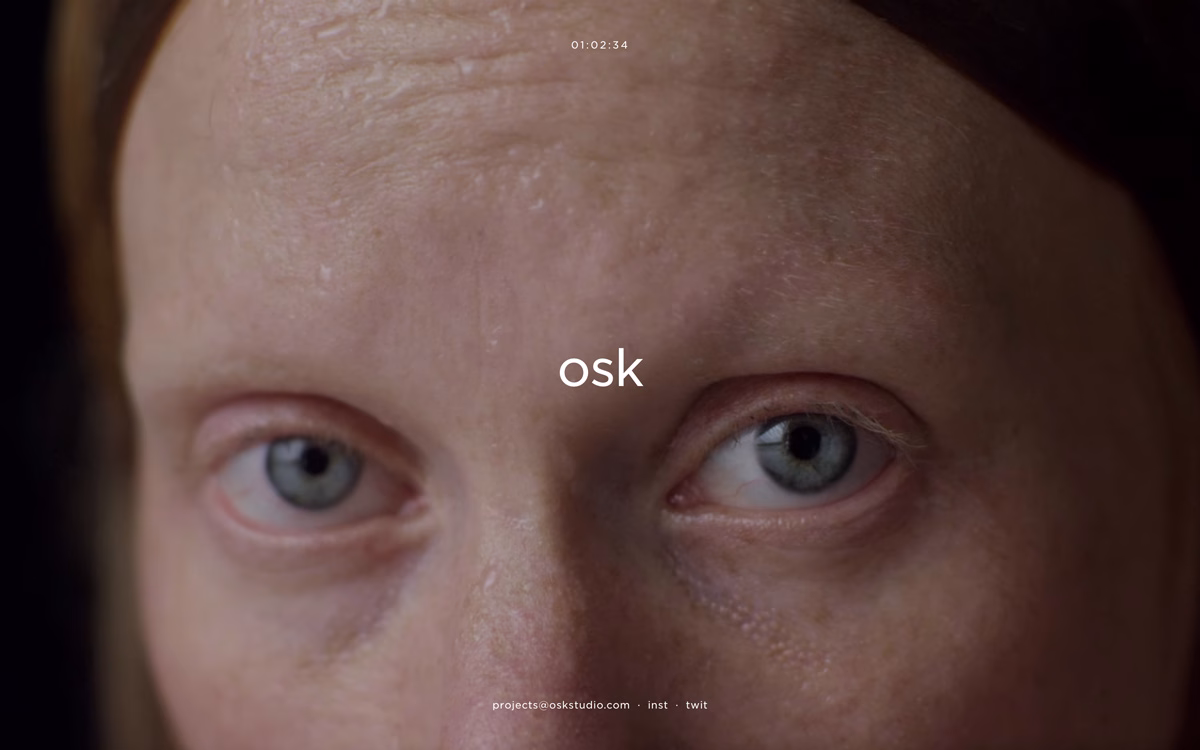 A close-up of a person's face, focusing on their eyes and forehead with soft lighting emphasizing skin texture.