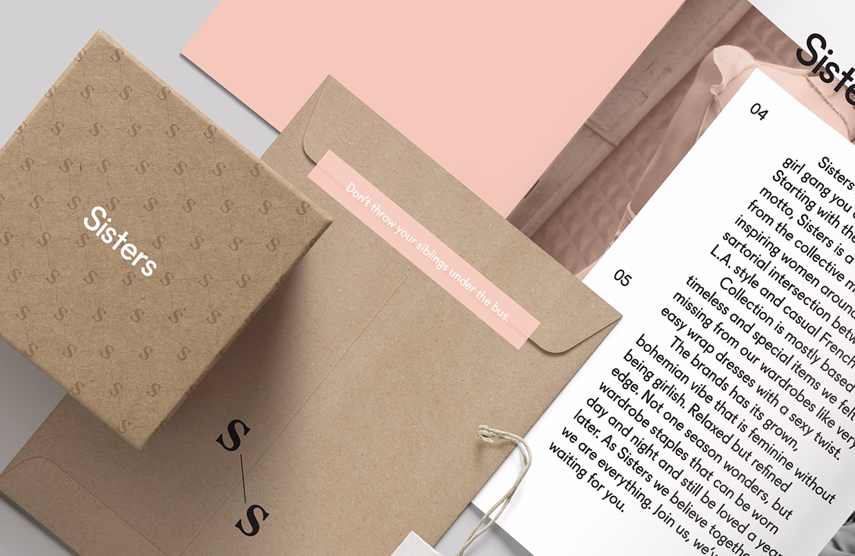 A craft paper box with "Sisters" printed in white rests next to a pale pink envelope and text about fashion.