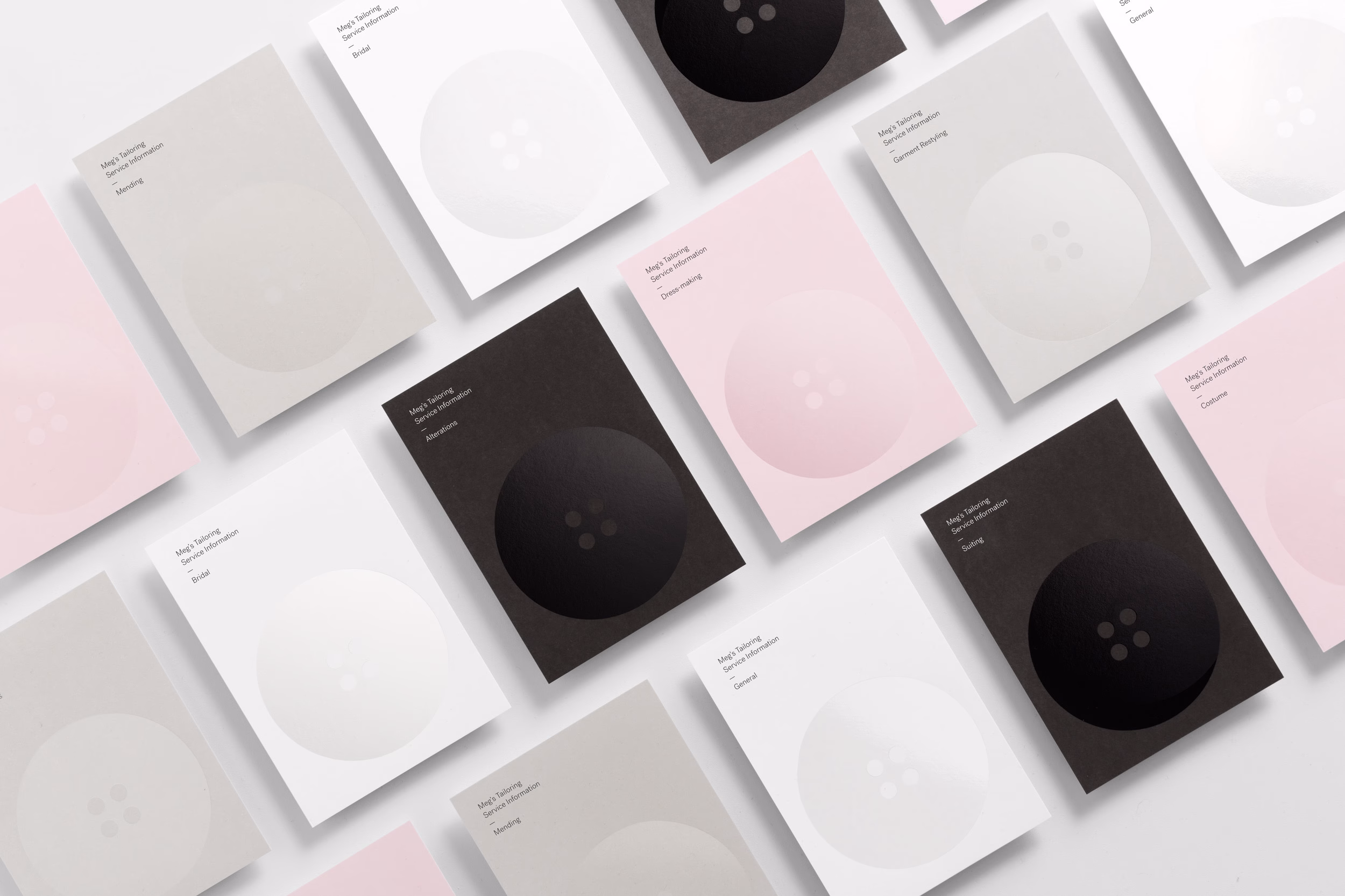A collection of cards in various colors, displaying simple designs with circles and text, arranged neatly on a surface.
