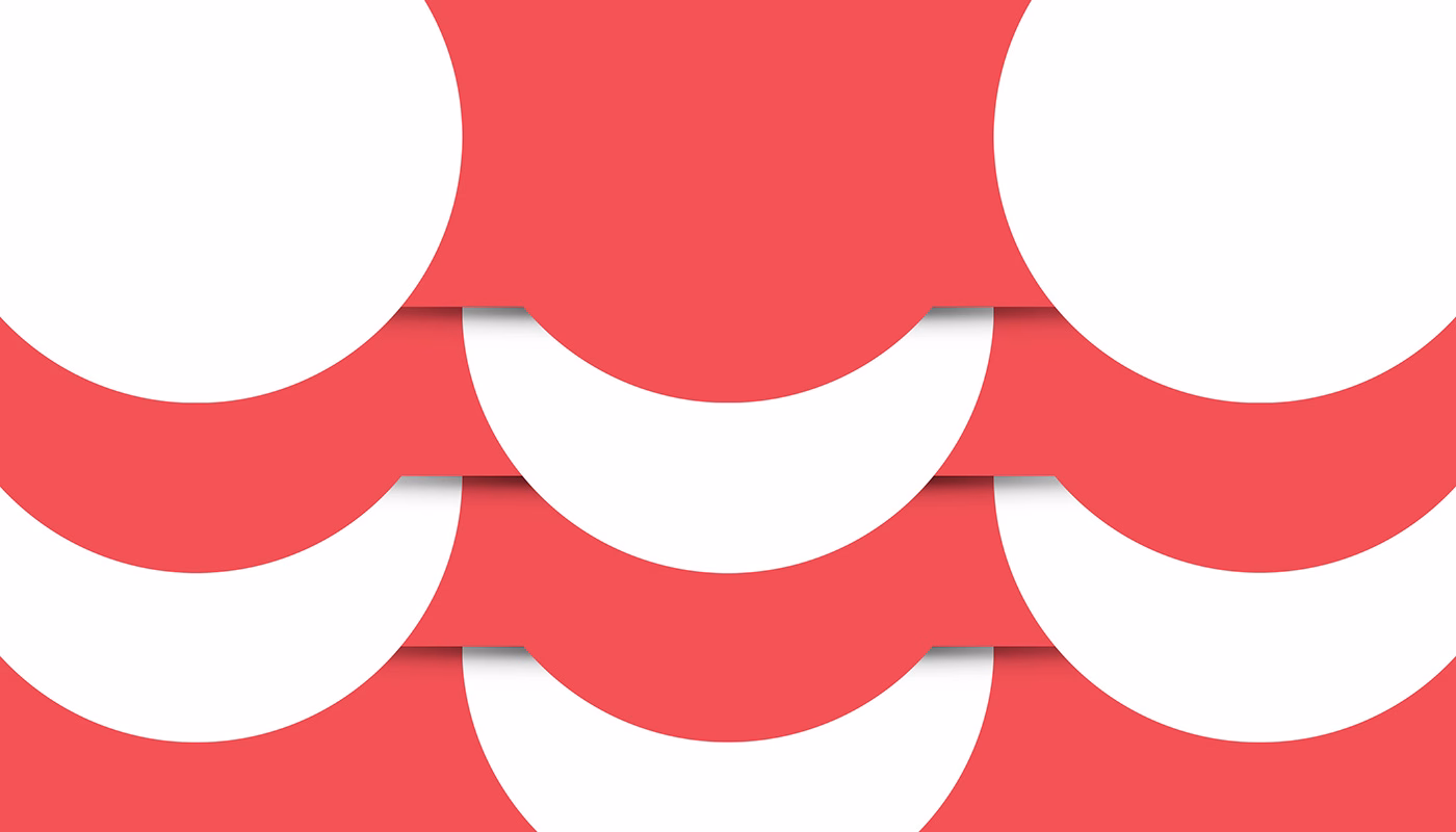 A pattern of overlapping red and white semicircles creates a dynamic, layered effect on a flat surface.