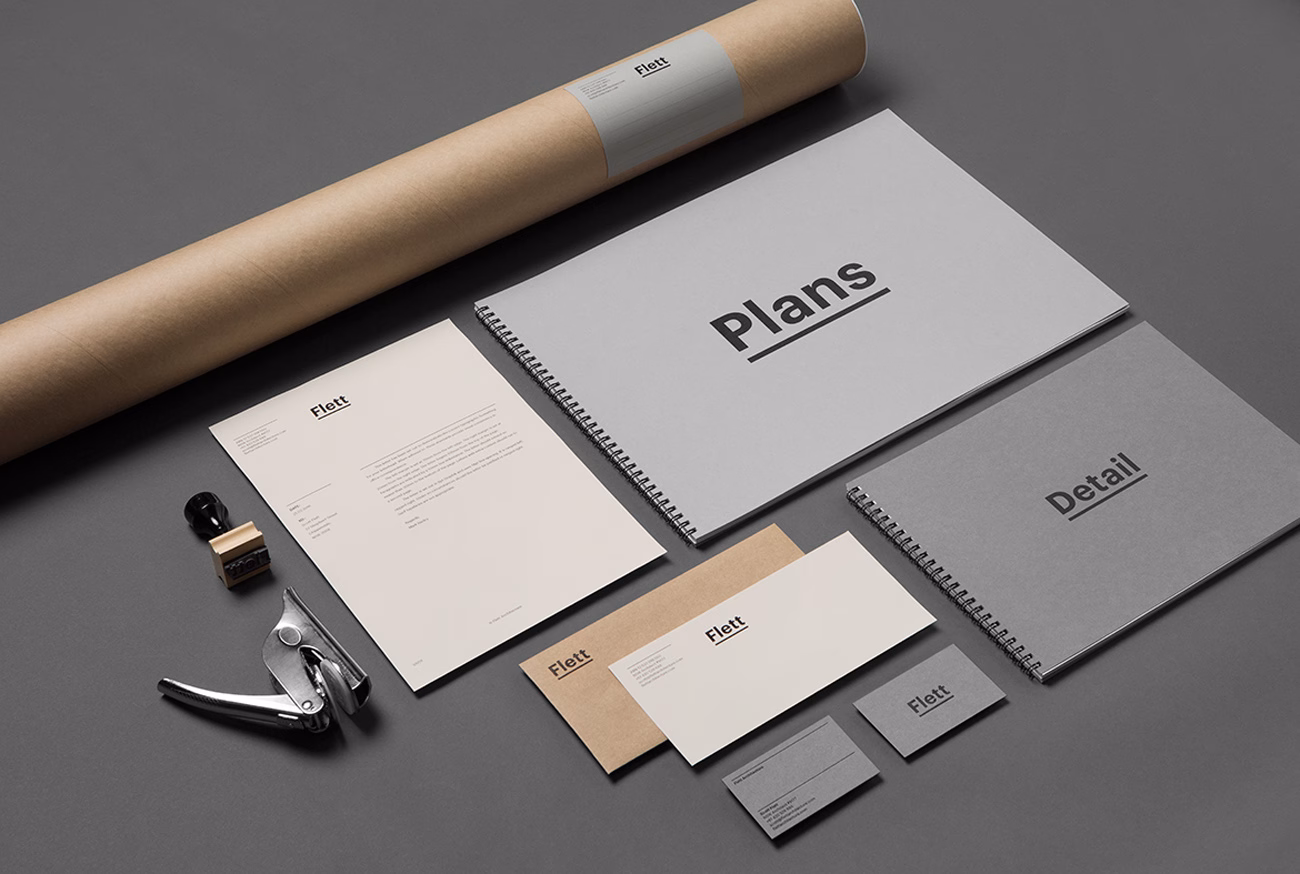 A collection of stationery and documents, featuring grey and beige tones with bold typography on covers and letterhead.