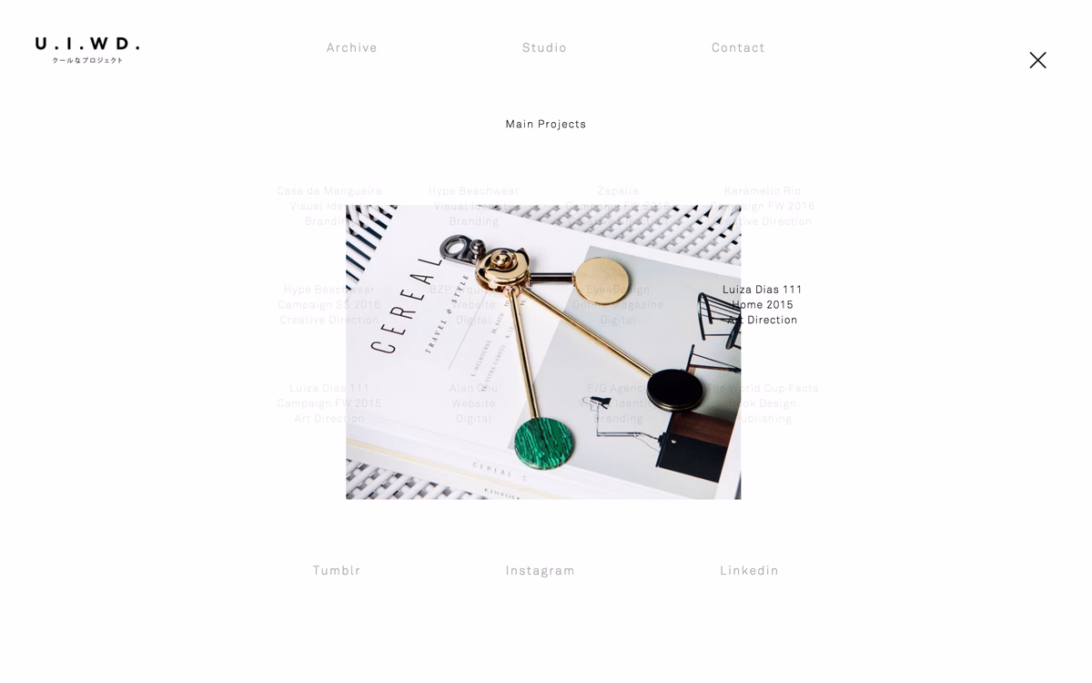 A gold and green decorative object rests on a magazine titled "Cereal," surrounded by a light, textured surface.