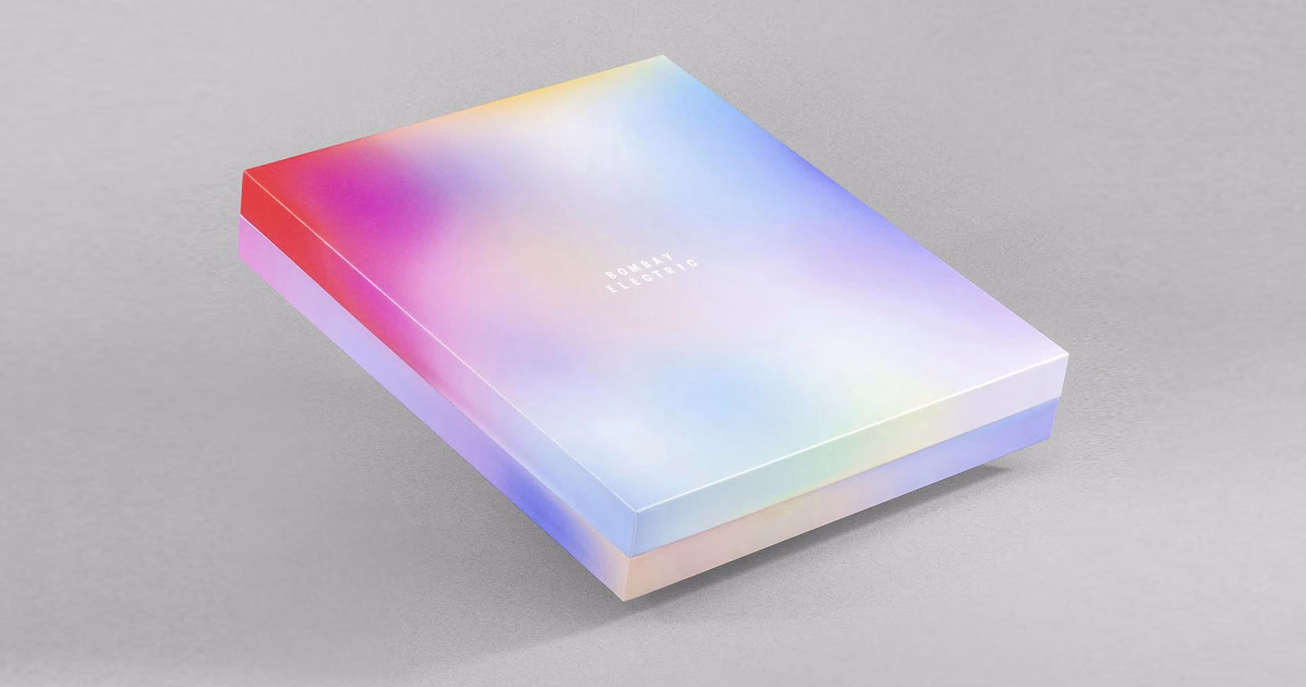A soft, gradient-colored box with a smooth finish, titled "Bombay Electric" in small, minimalist type.