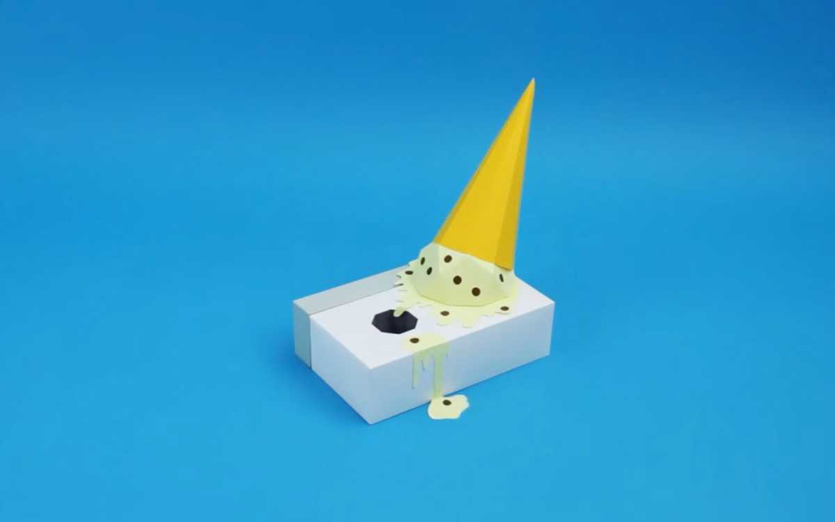 A yellow party hat rests atop a melting, green ice cream cone on a white box, set against a bright blue background.