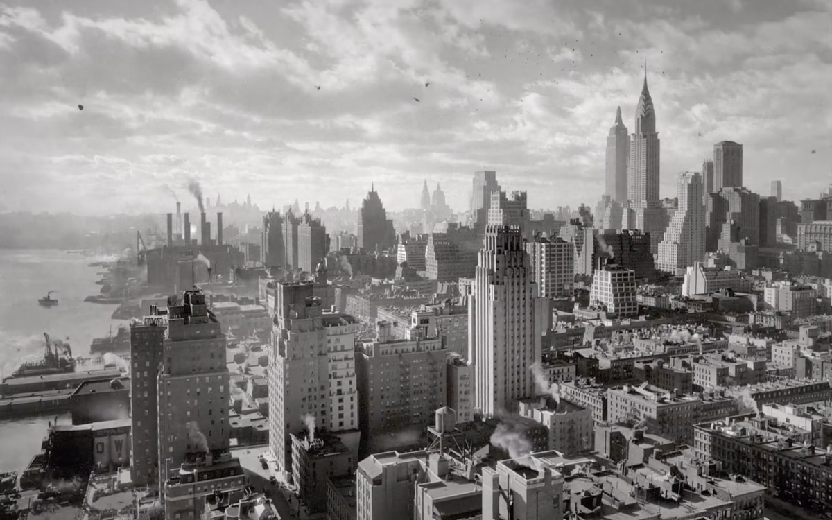 A monochrome cityscape shows historic skyscrapers casting shadows over bustling streets and boats on the water.