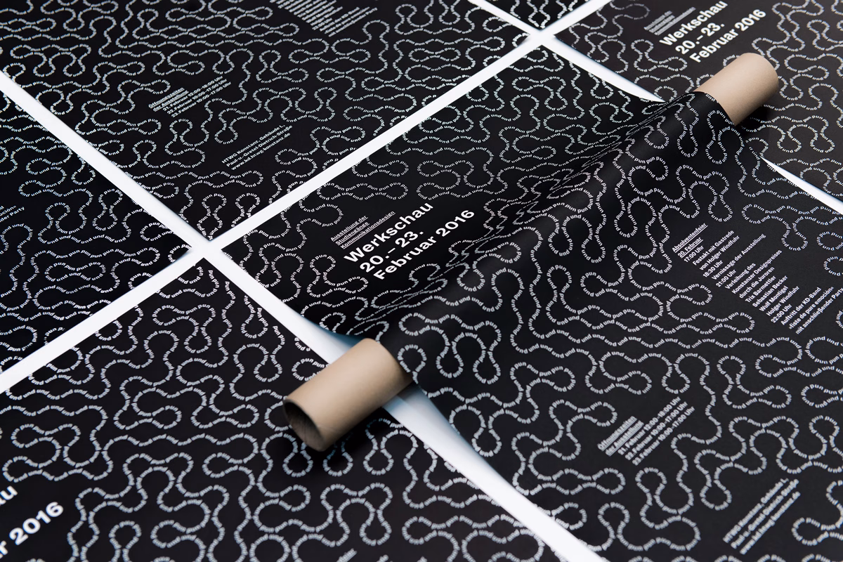 A rolled poster reveals a black background with white text and intertwined lines, showcasing event details for 2016.