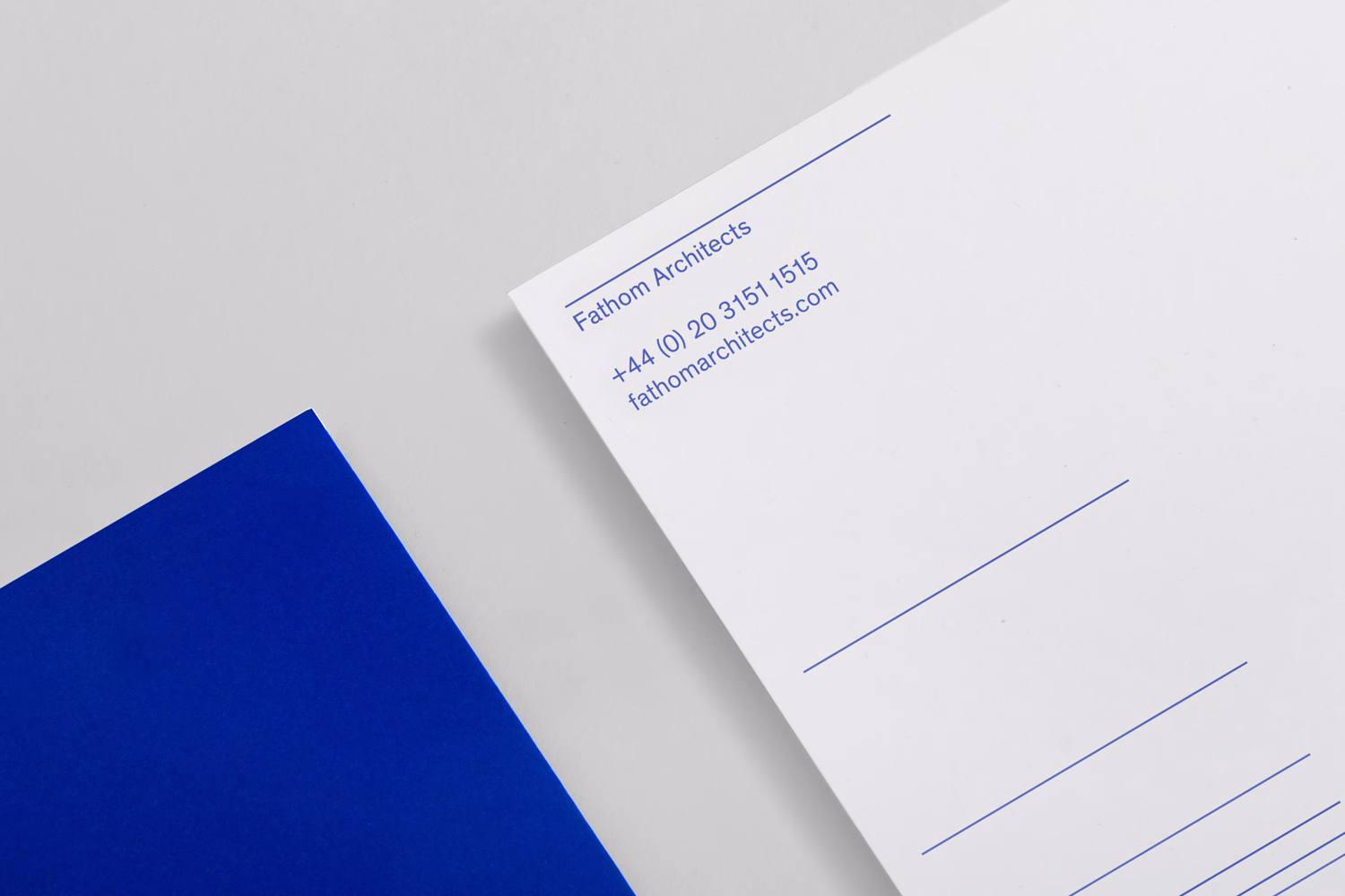 A white letterhead with blue typography features contact details and the name "Fathom Architects" against a grey background.