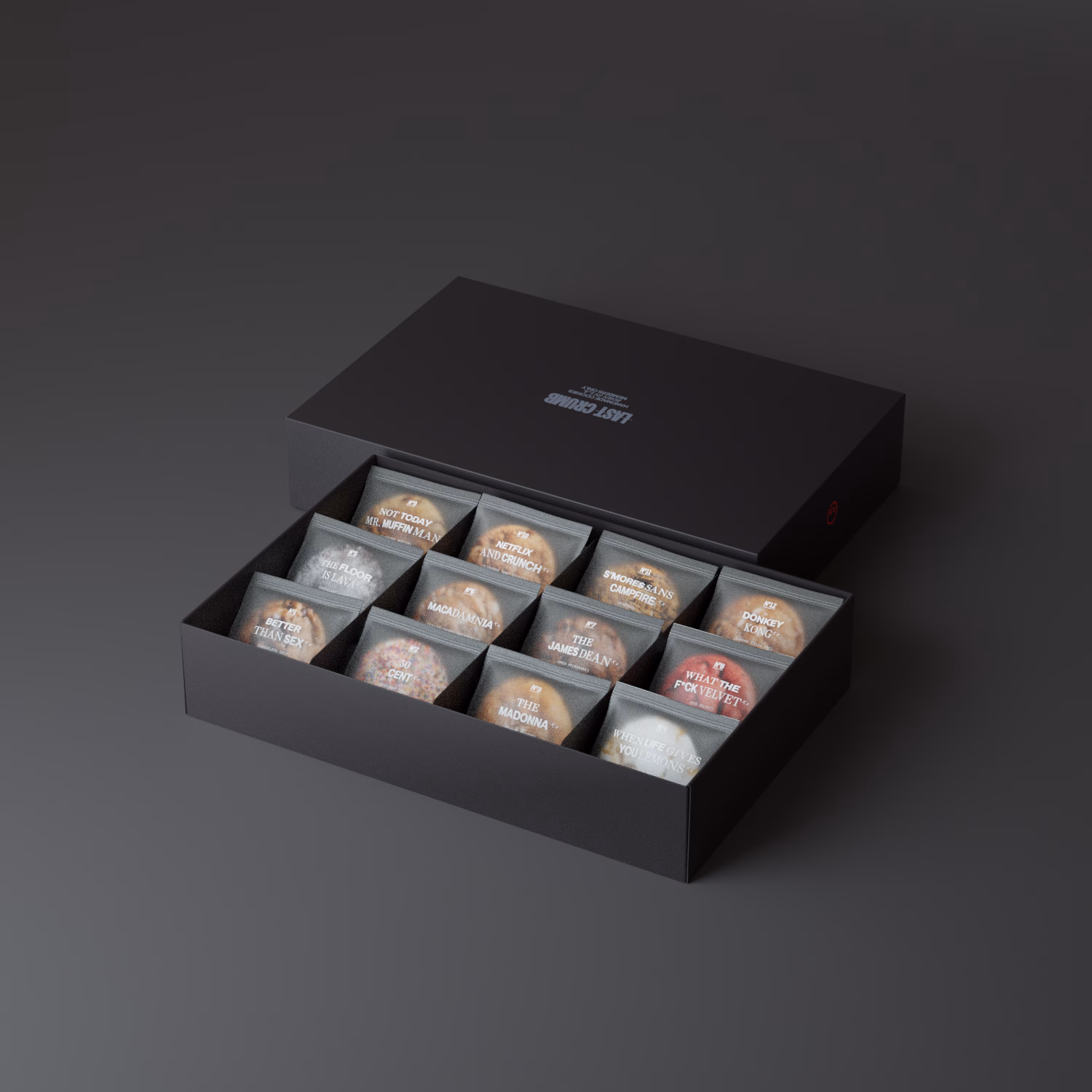 A sleek black box holds twelve pastry items, each labeled with playful names in white typography.