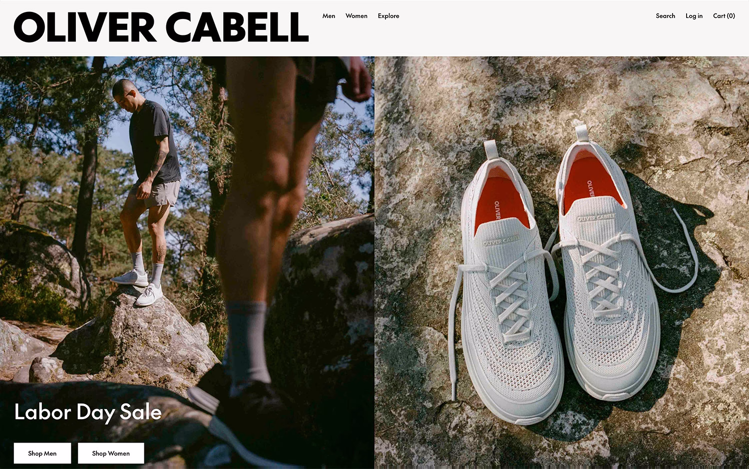 A person in a black shirt and shorts stands on a rock in a forest, wearing light grey sneakers with red interiors.