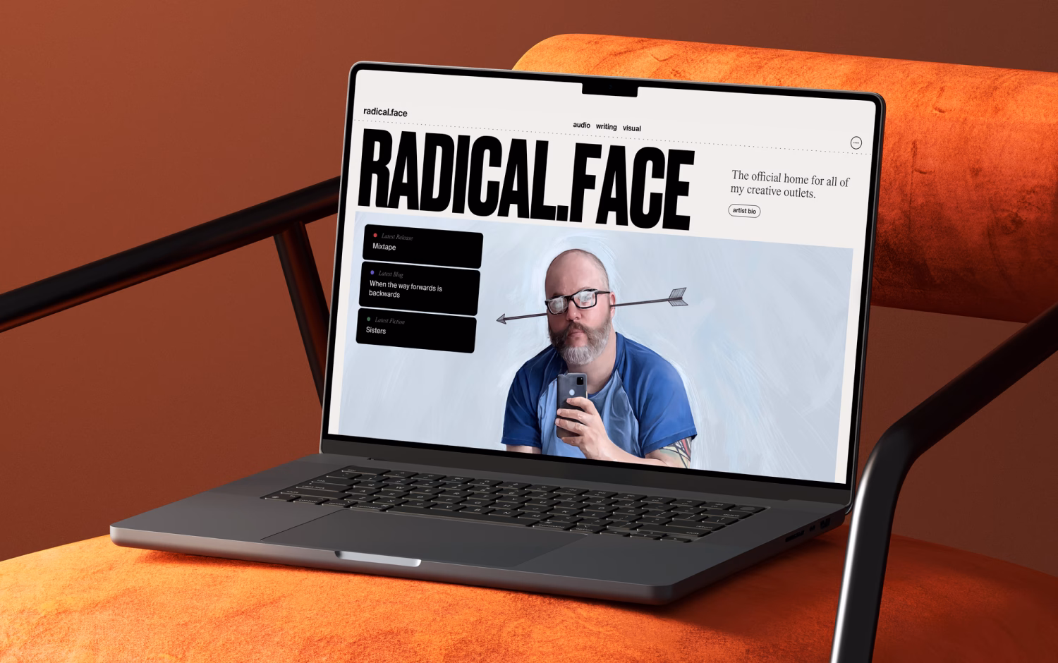 Laptop displays Radical Face website with a man and arrow illustration.