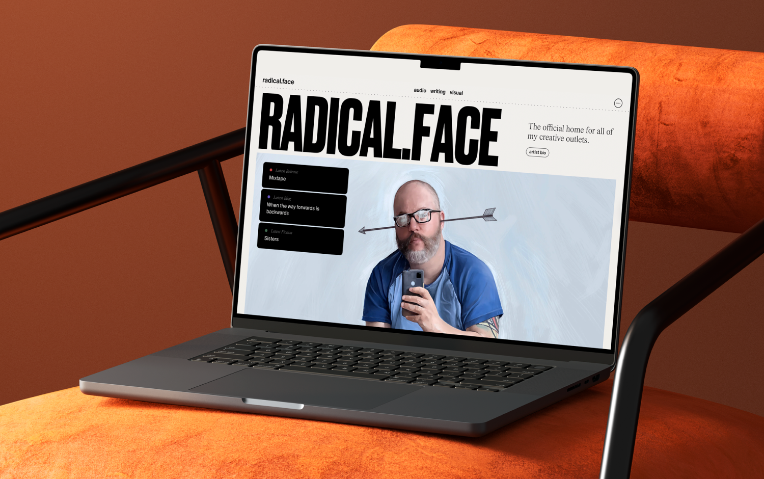 Laptop with "Radical Face" website showing a man with an arrow through his head.