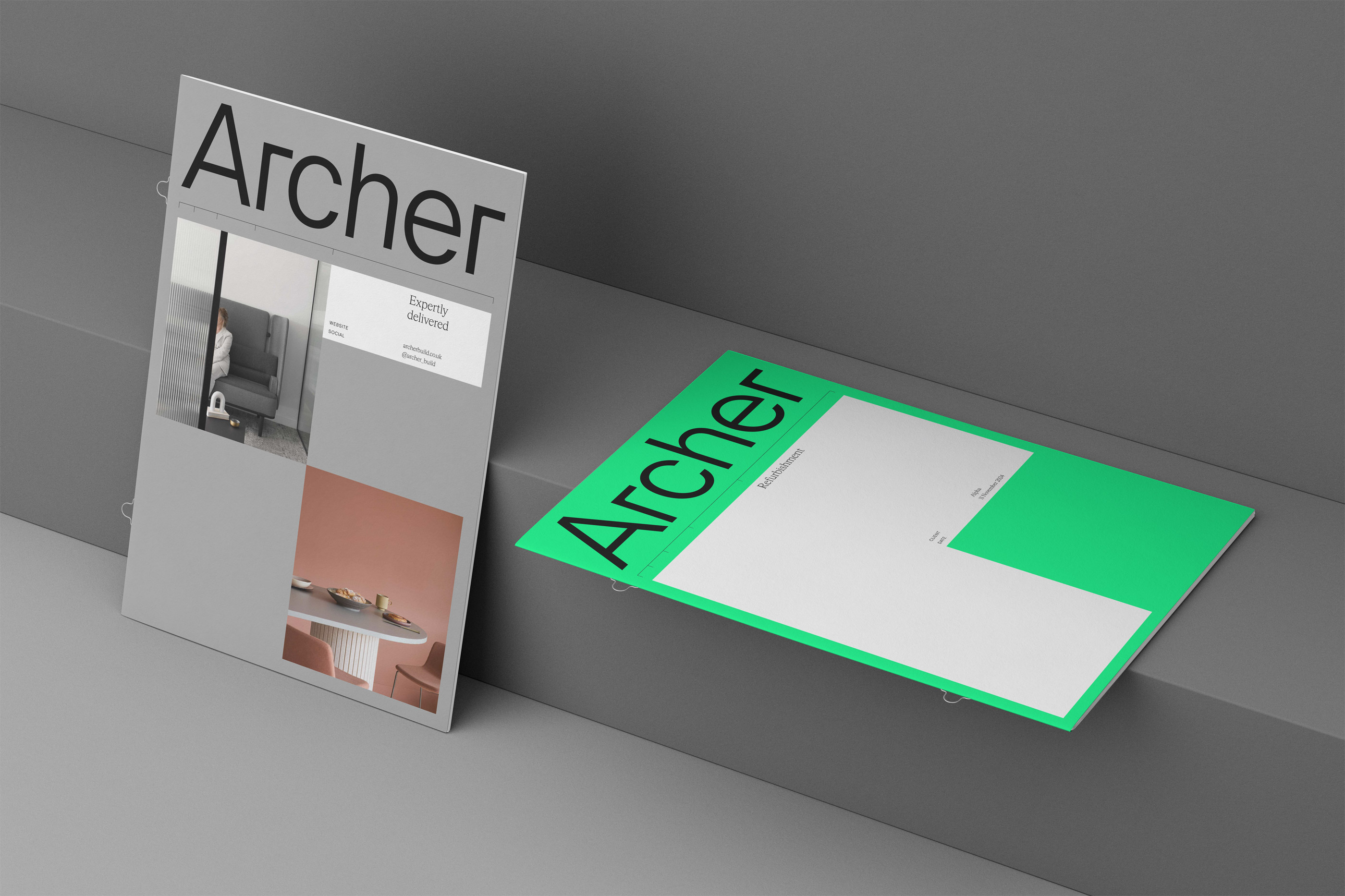 Two modern brochures titled "Archer" with minimalistic design on a gray surface.