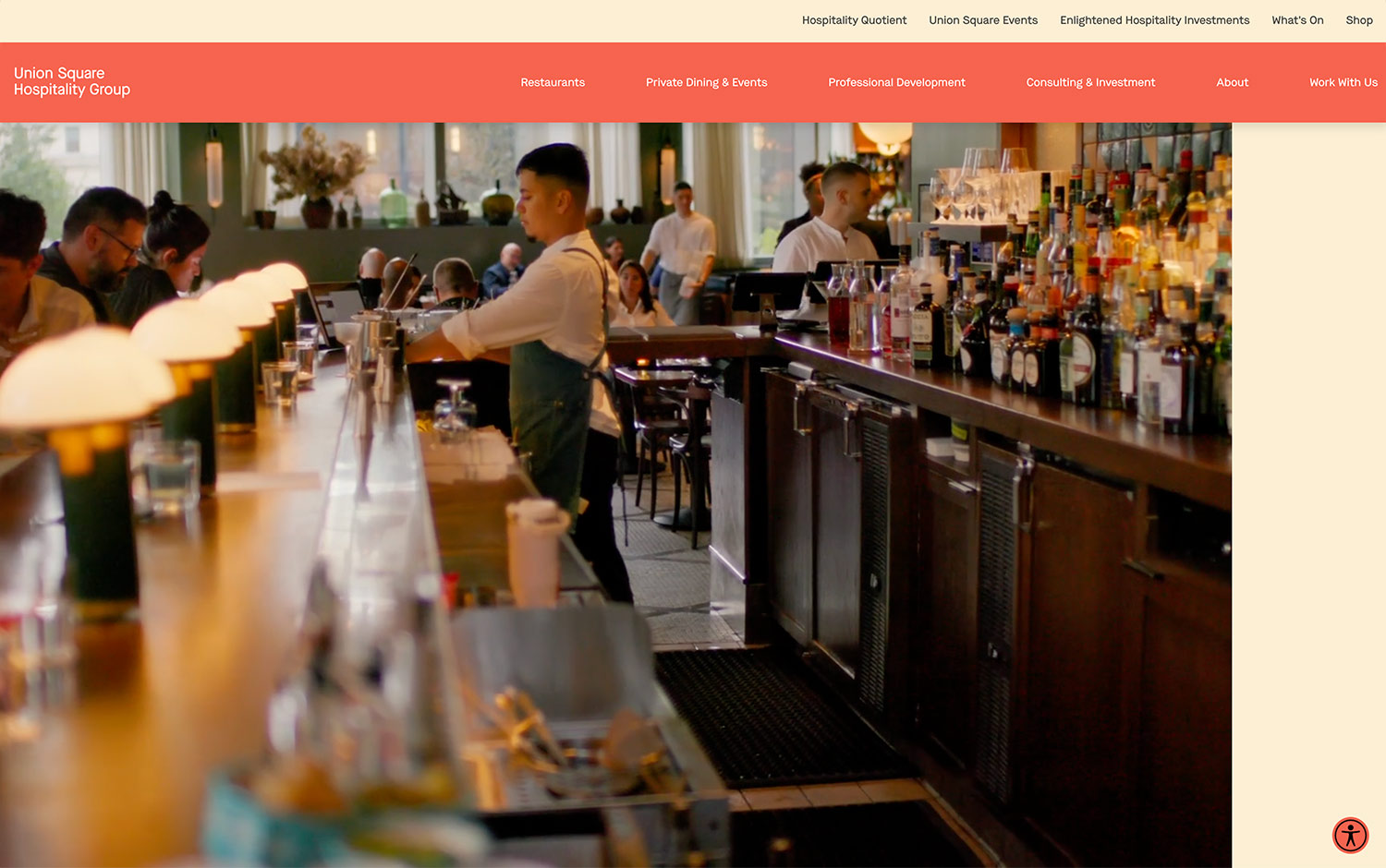 A busy bar scene with bartenders serving and bottles lined up on shelves.