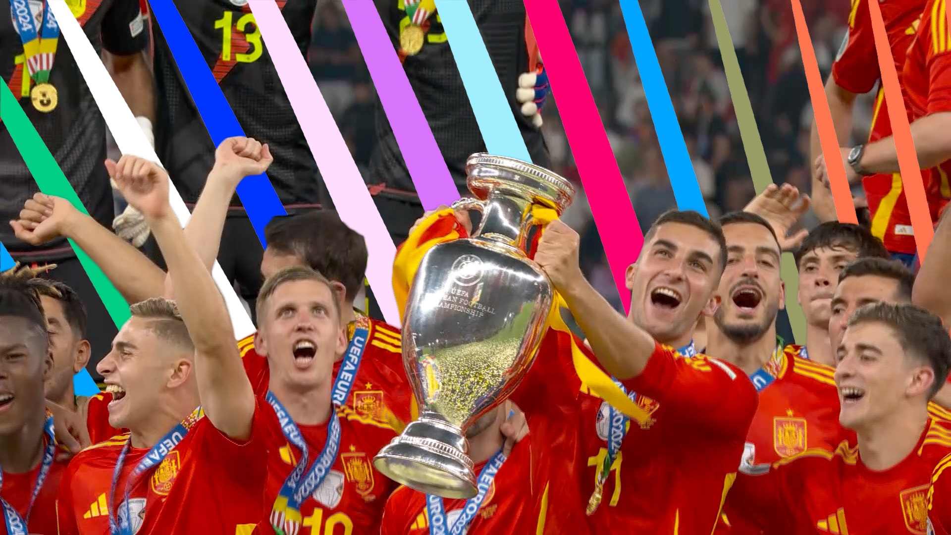 Spanish football team celebrating with the Euro trophy, wearing red jerseys and medals.