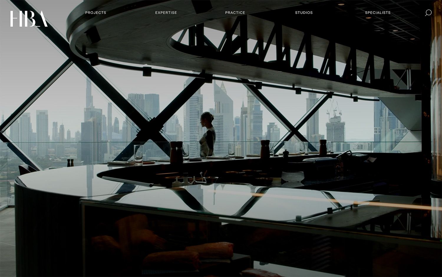 Modern indoor restaurant with skyline city view through large windows.