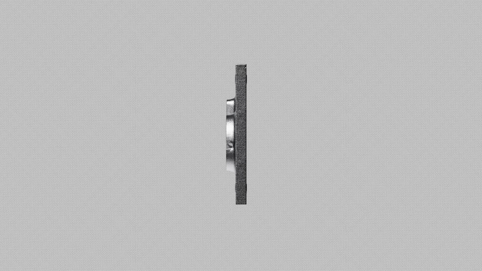 A flat, gray surface features a shiny, circular component protruding from one side.