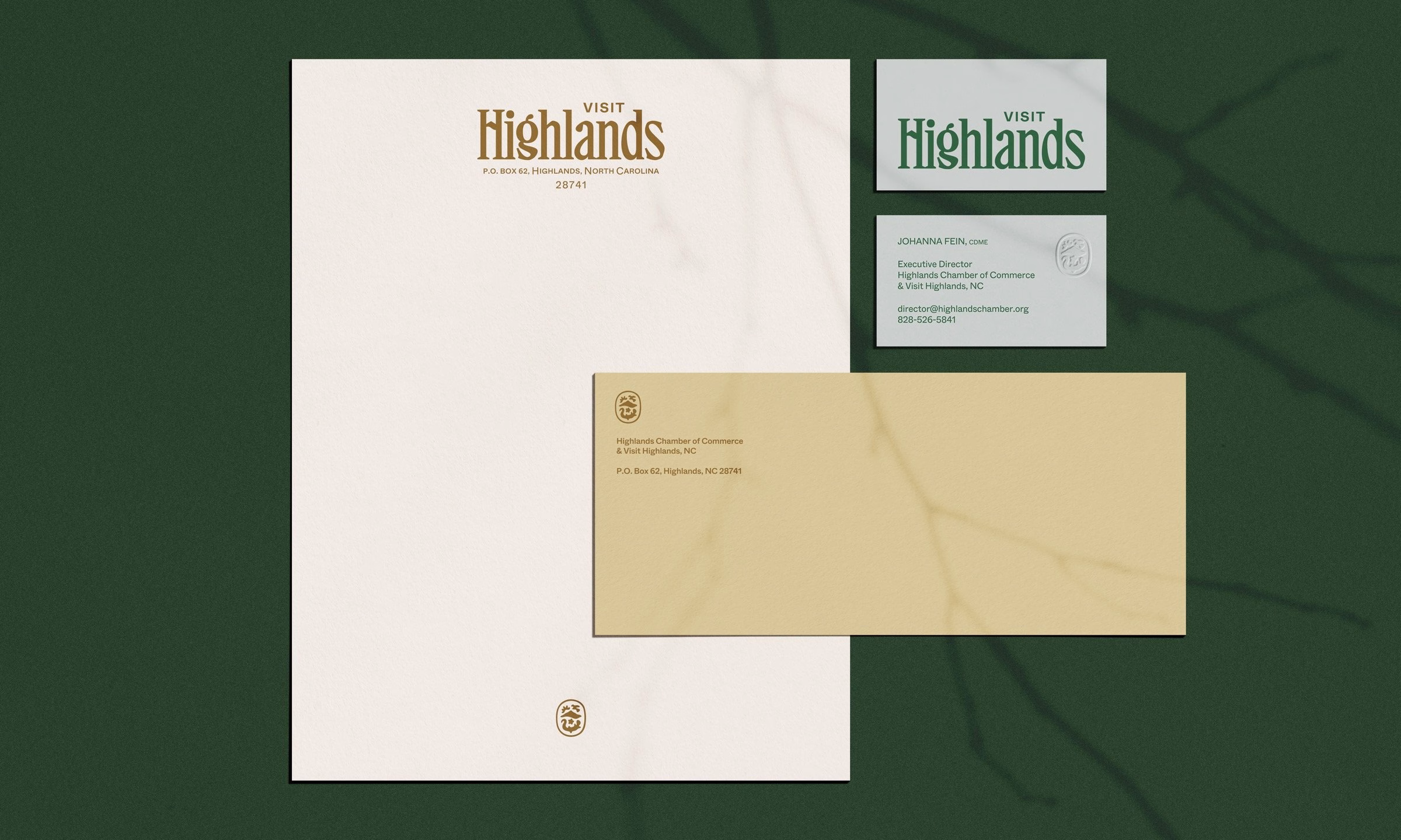 Brand identity for Visit Highlands featuring elegant typography on cream and green materials.