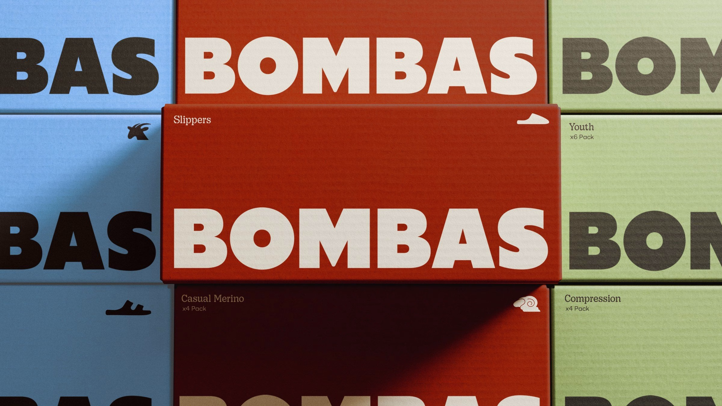 Colorful Bombas packaging with bold typography features a red box prominently displaying the brand name against other colors.