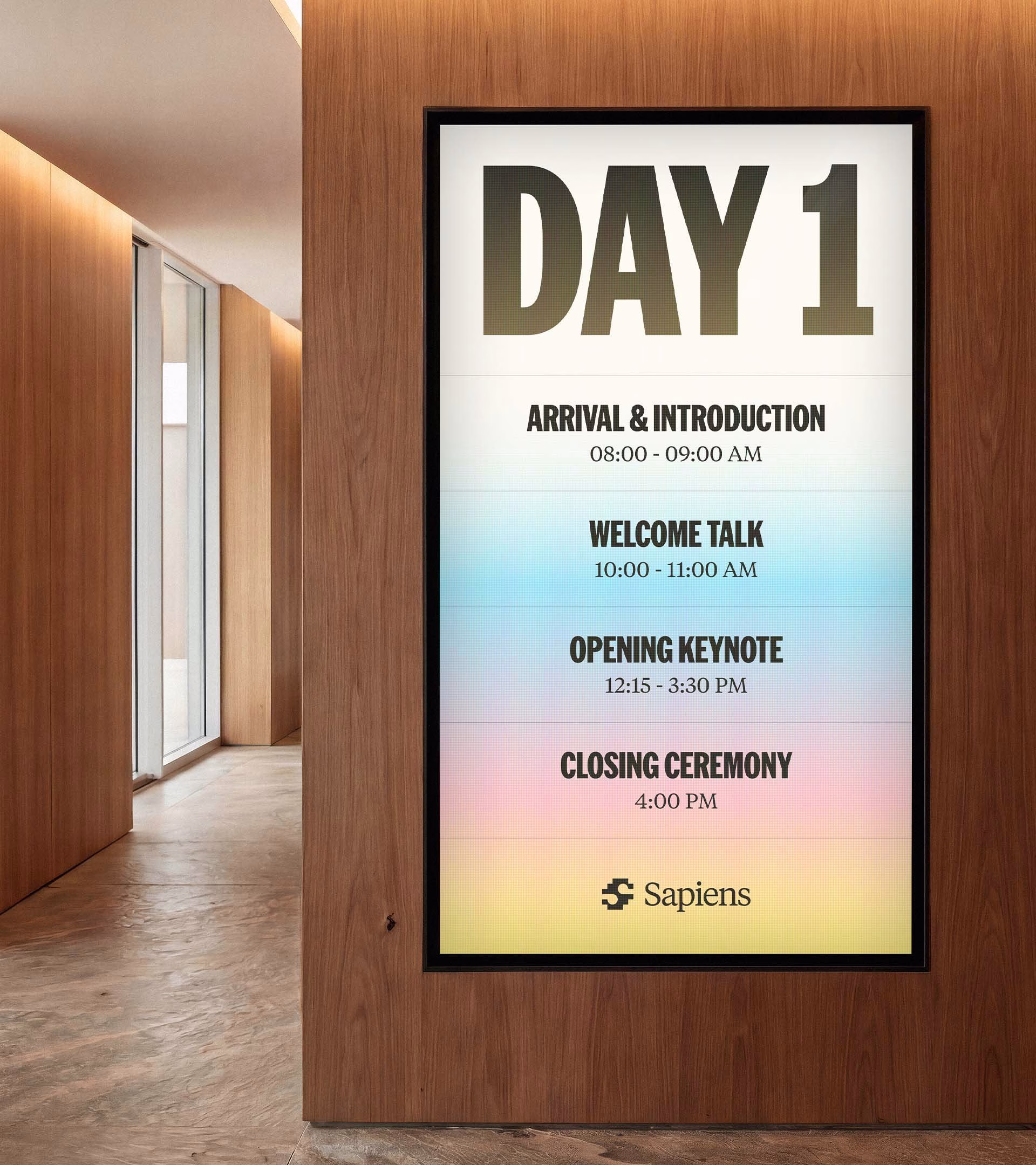 A wall-mounted schedule display features bold typography on a gradient background, highlighting events for Sapiens.