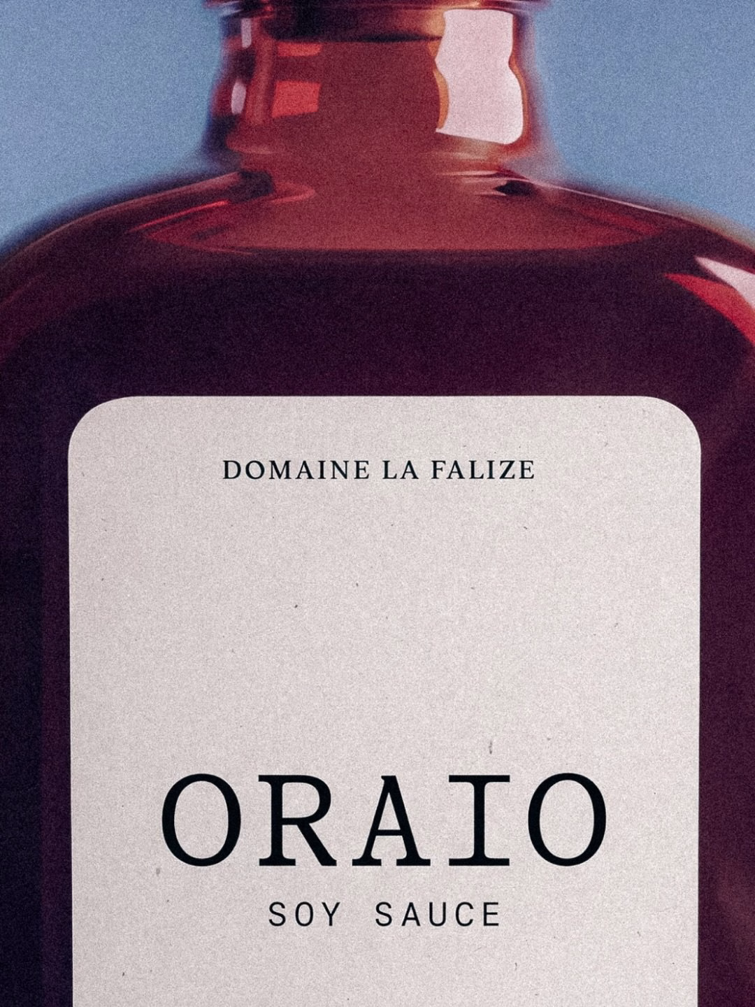 Oraio soy sauce packaging with a dark brown glass bottle and a minimalist label featuring bold typography.