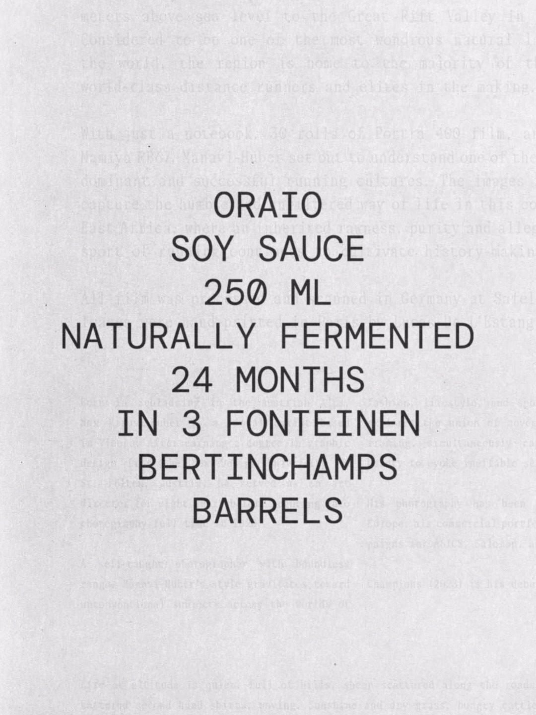 Label for Oraio soy sauce in bold black typography, detailing 250 ml, naturally fermented for 24 months in barrels.