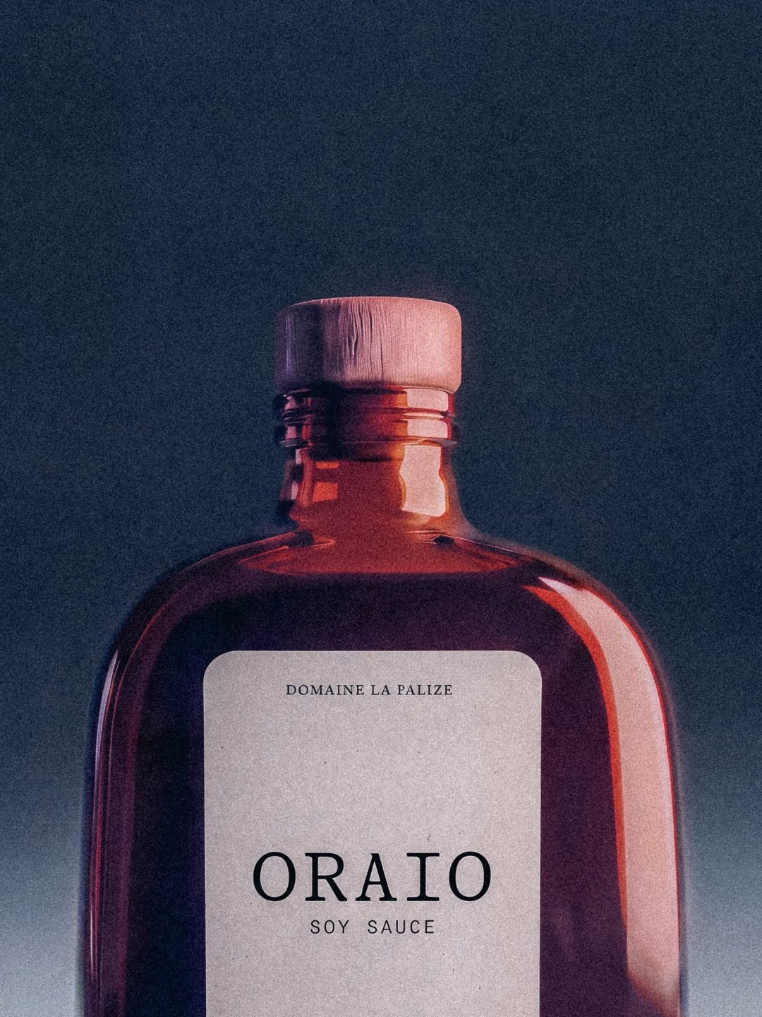 A deep red bottle with a wooden cap and a minimalist label featuring the text "Oraio Soy Sauce."