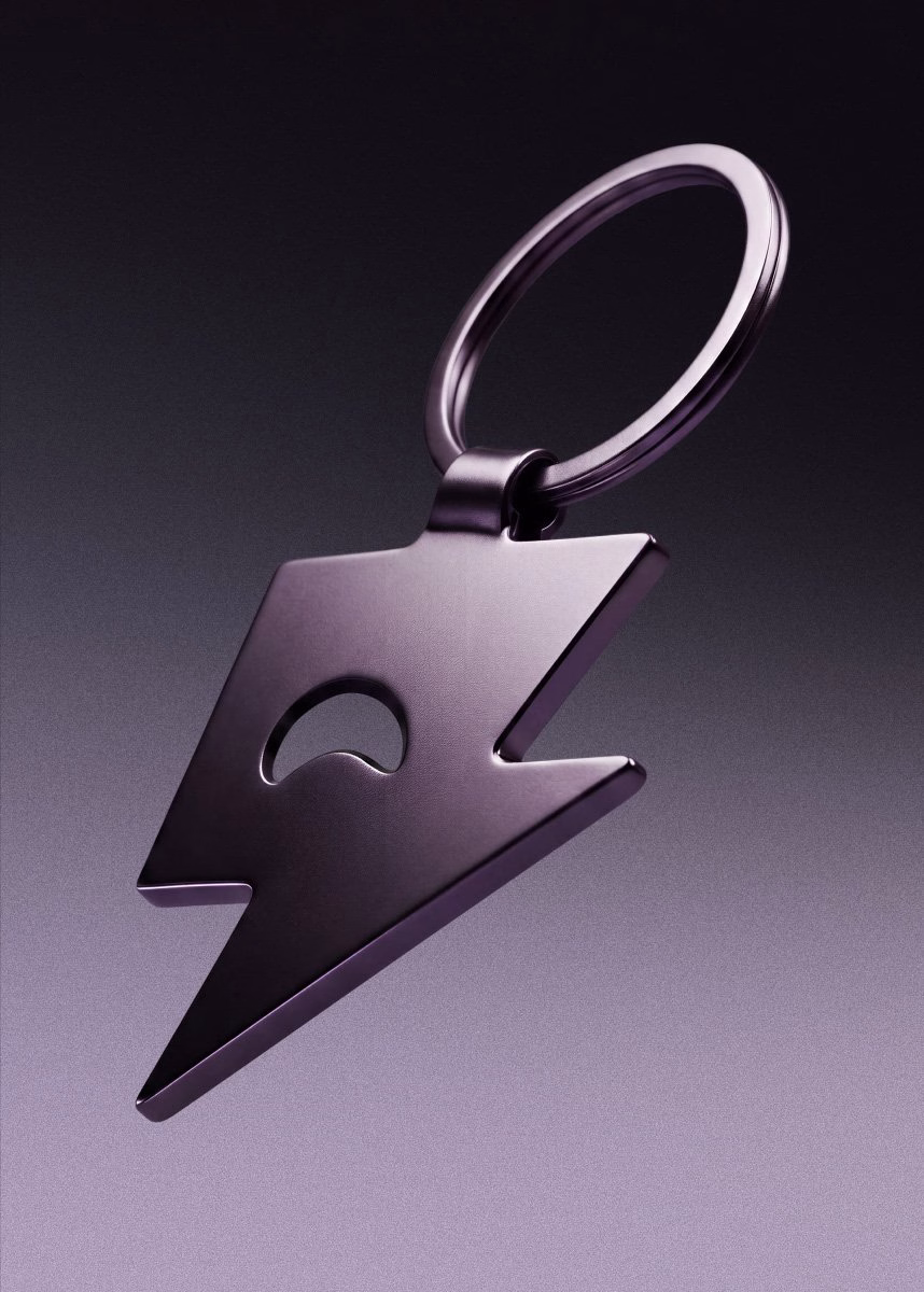 A sleek, purple lightning bolt keychain featuring a cut-out design, representing Betr's gaming super app branding.