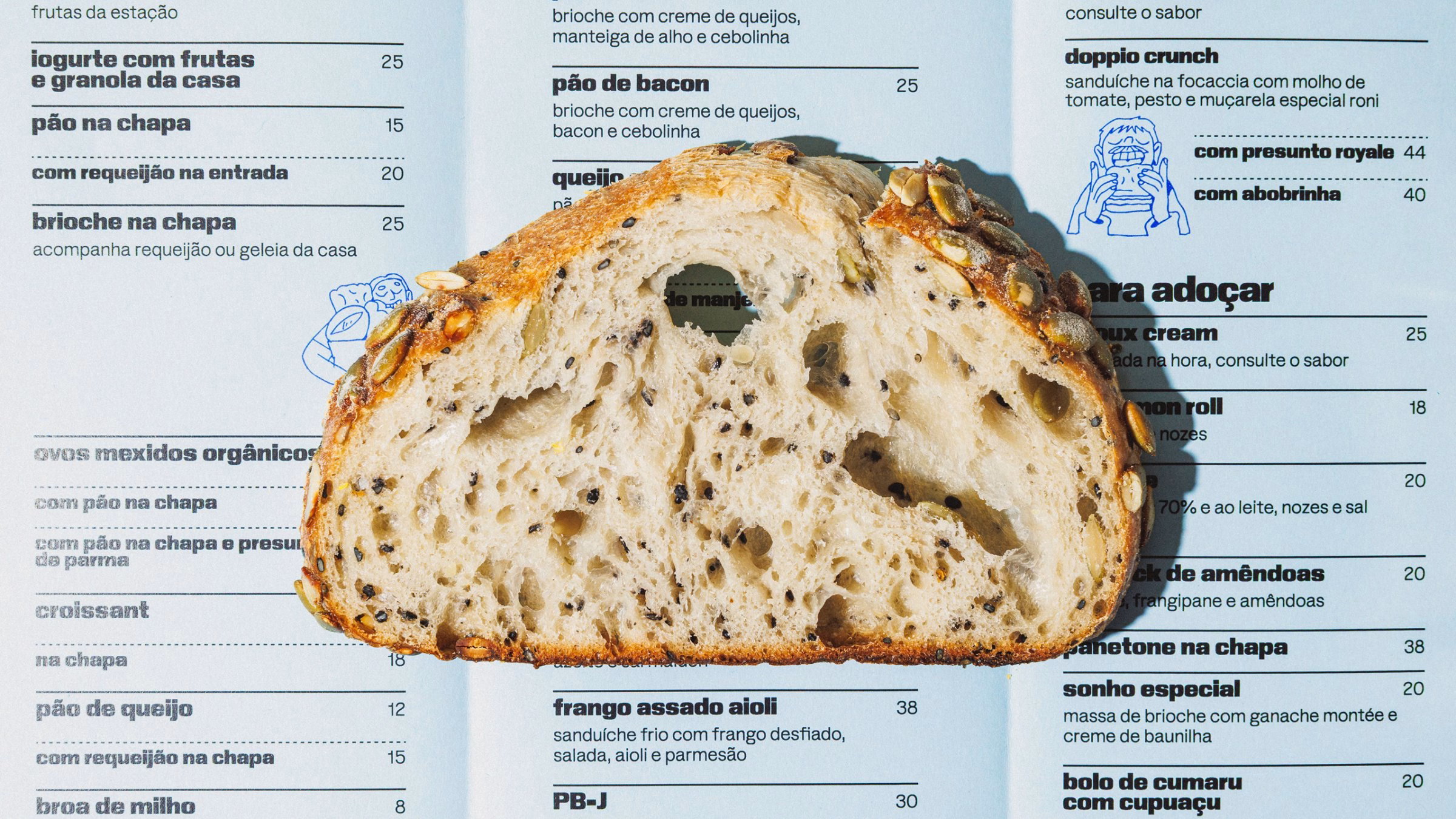 A close-up of a bread slice showcases its textured interior, placed over a blue menu featuring bakery items and prices.