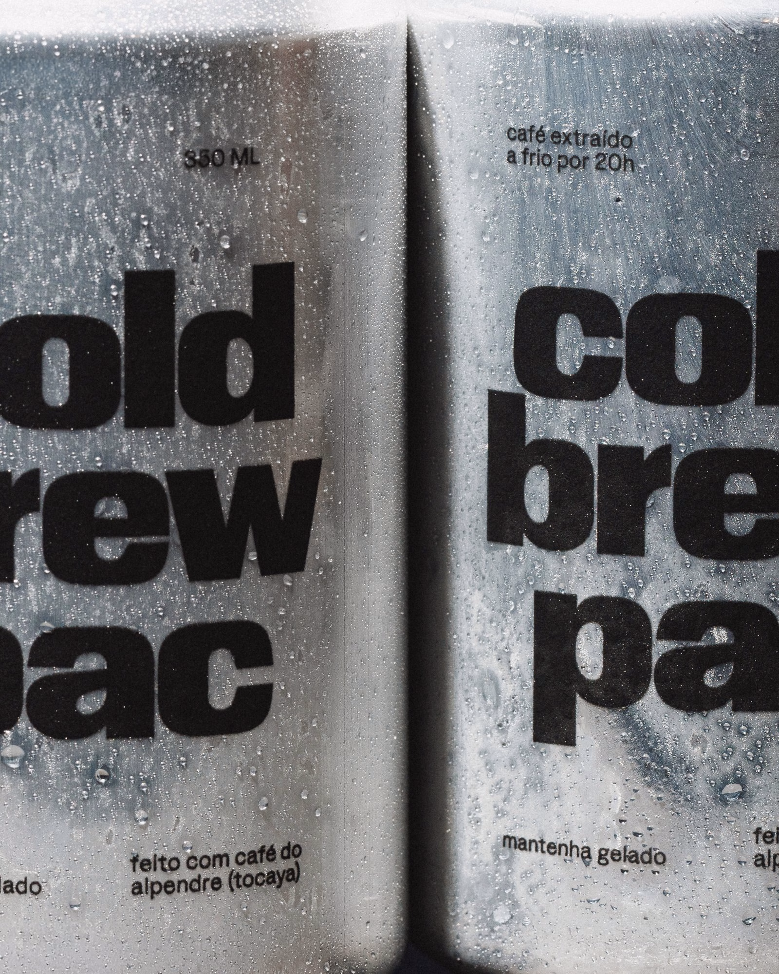 Two metallic containers of cold brew coffee, featuring bold typography and water droplets on the surface.