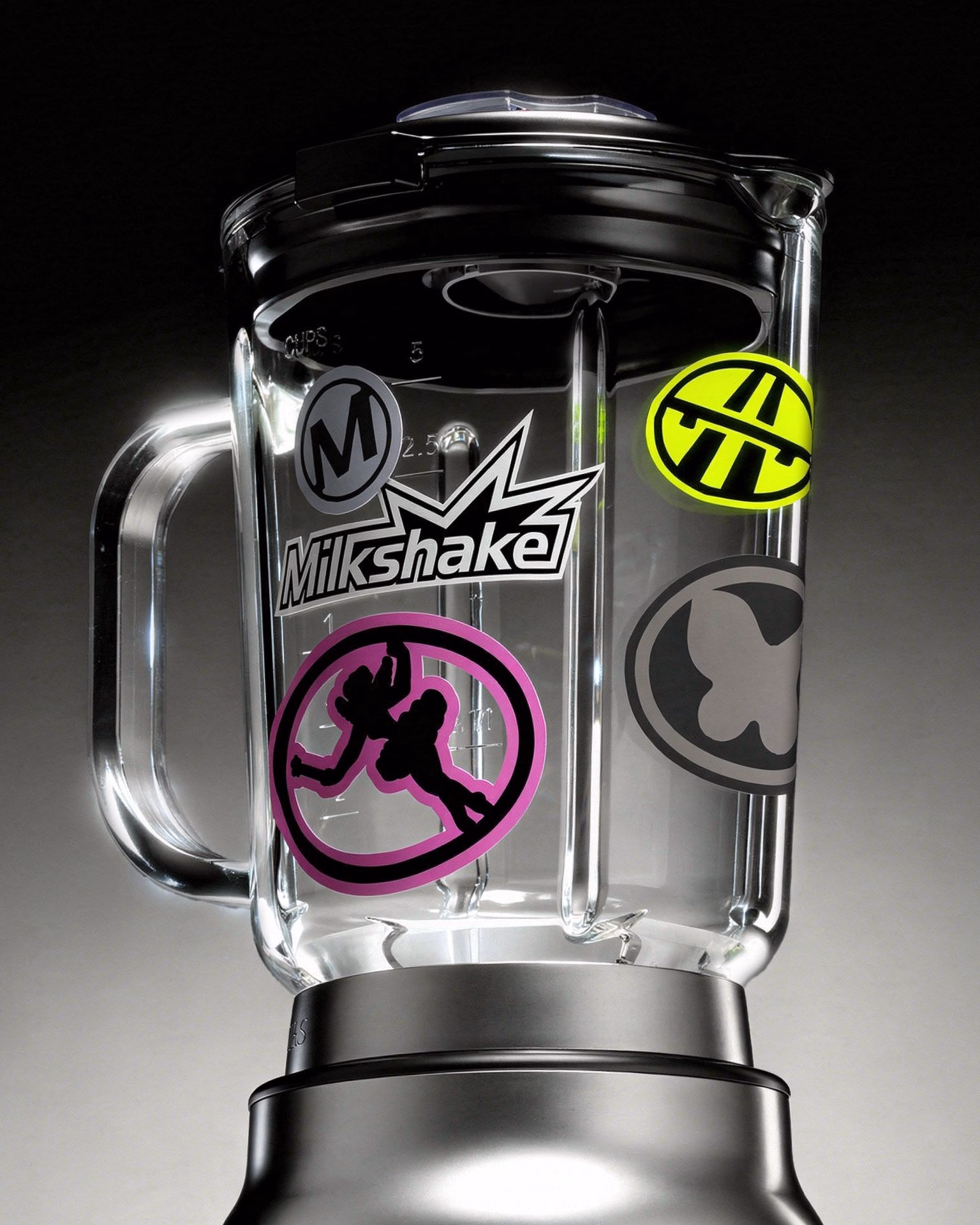 A clear blender adorned with colorful stickers, embodying Milkshake's playful car-culture identity.