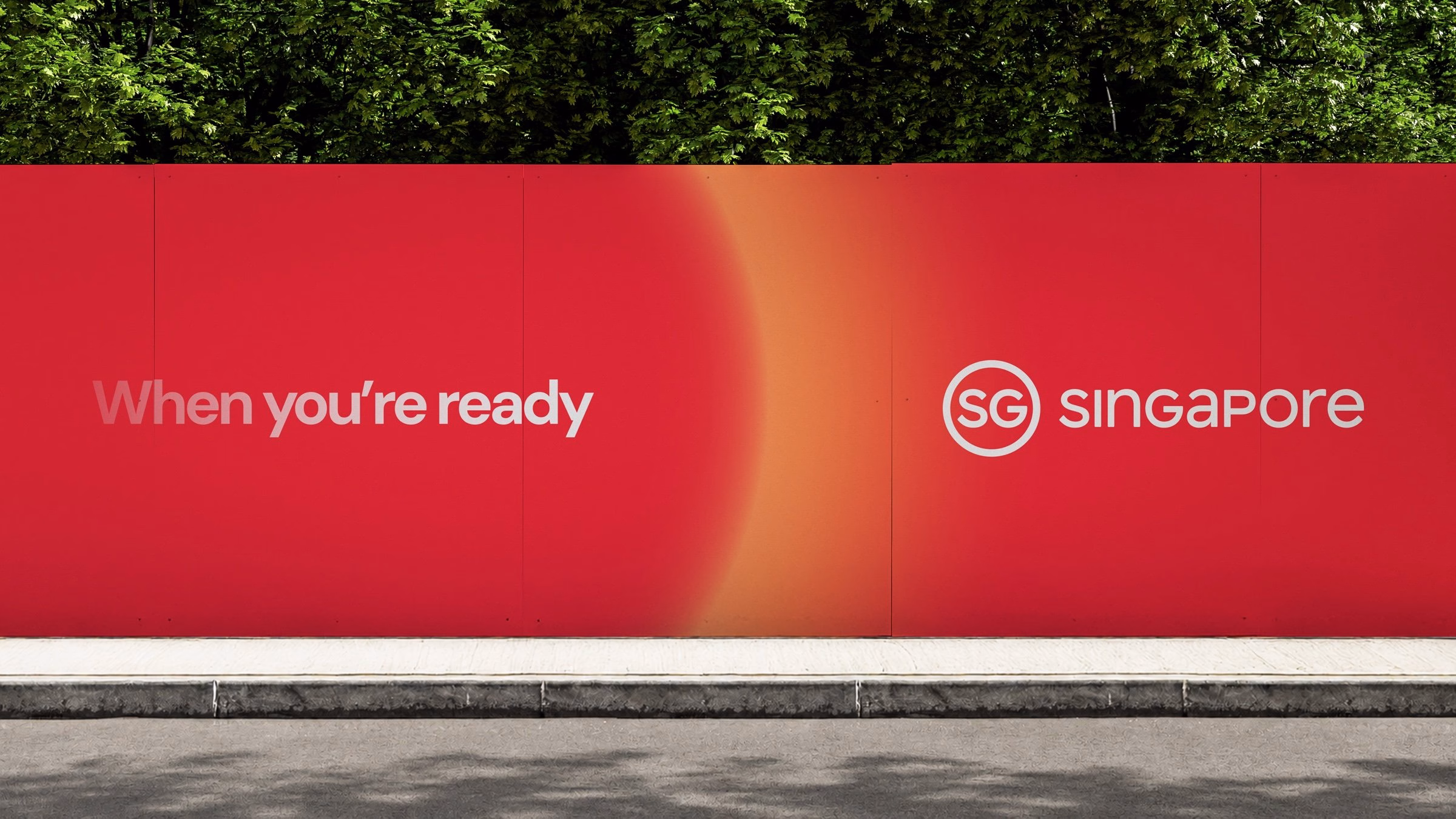 A vibrant red wall displays the text "When you're ready" in white, alongside the logo for "SG Singapore" in bold typography.