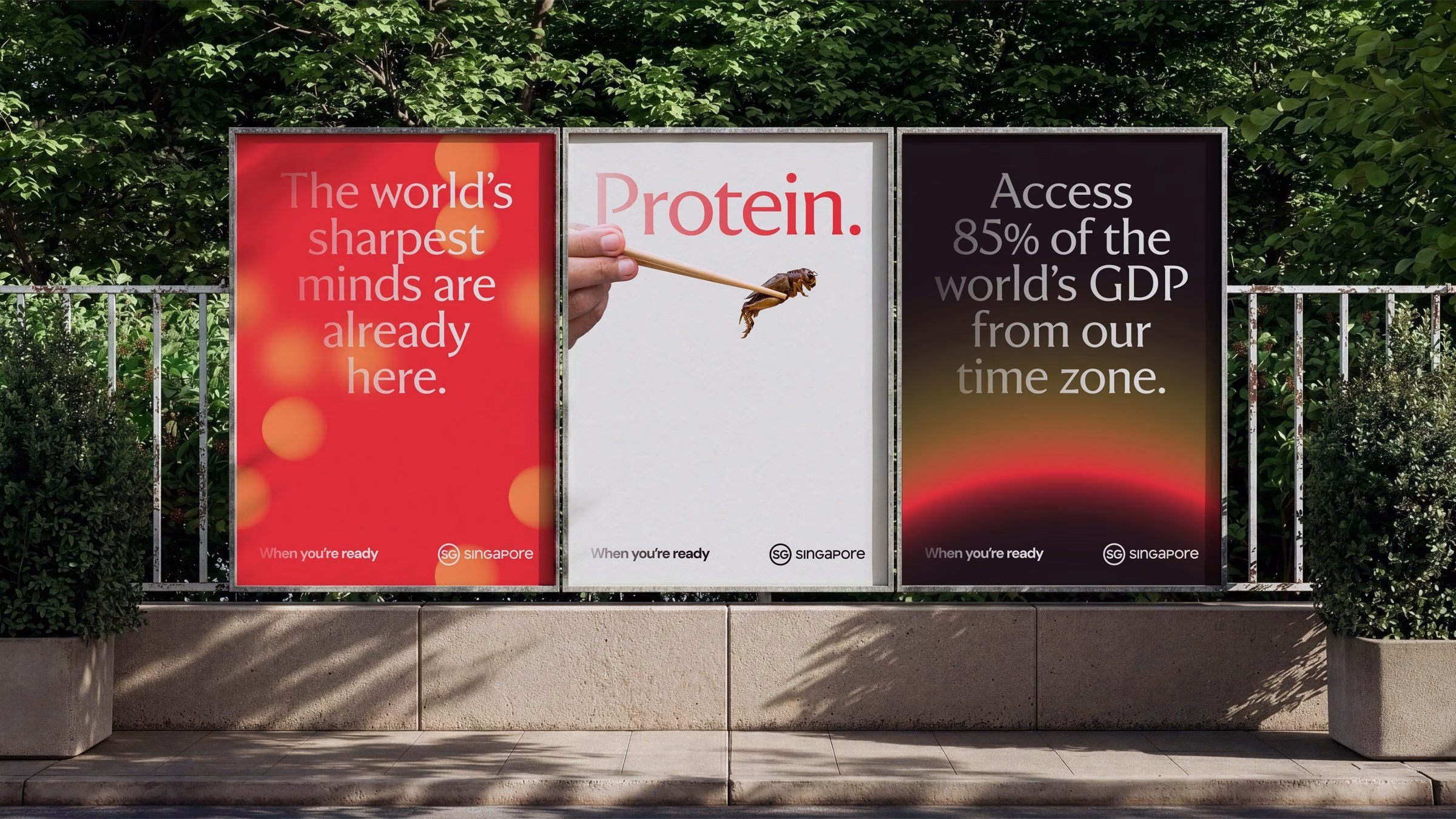 Three colorful billboards highlight Singapore's branding, featuring red, white, and black backgrounds with bold text.