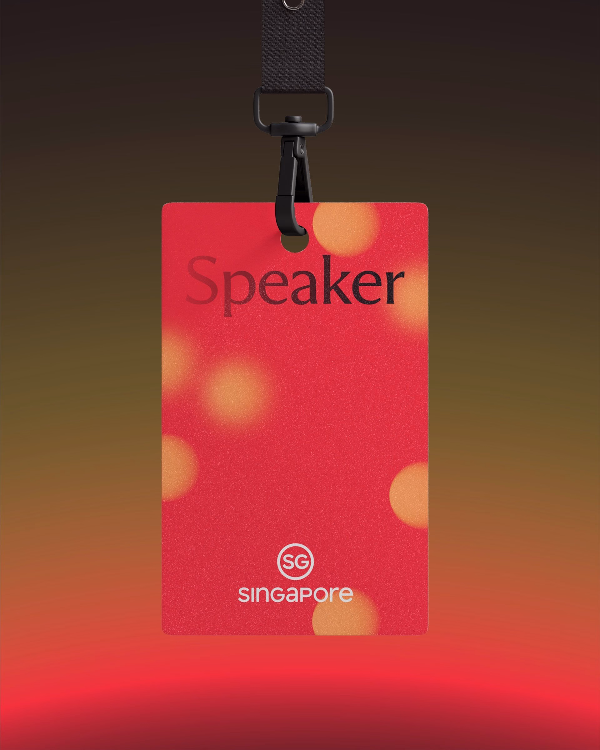 A red name tag features the word "Speaker" in black and the logo "SG Singapore" against a blurred gradient background.
