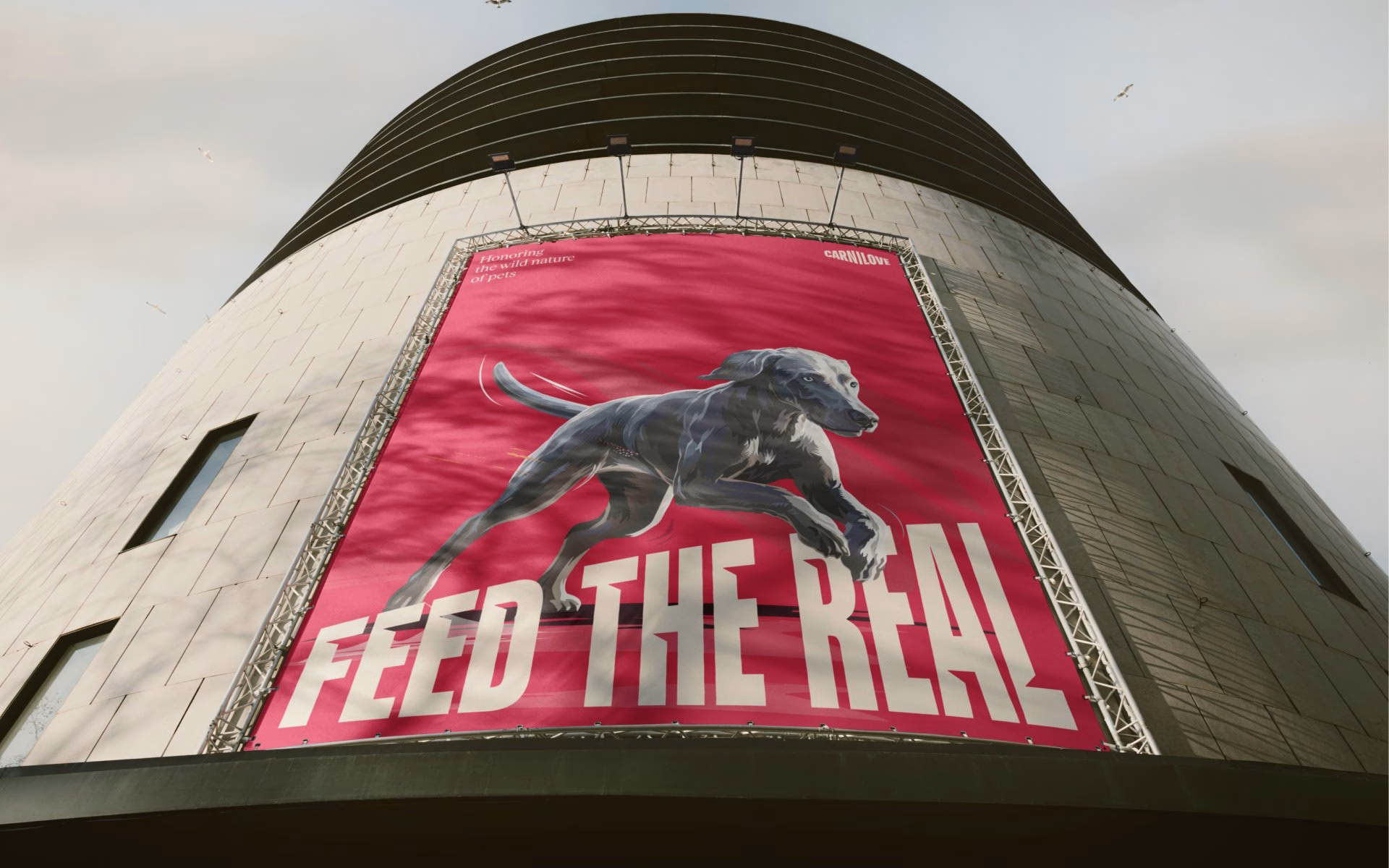 Bold pink billboard featuring a running dog and the text "FEED THE REAL" for Carnilove’s branding campaign.