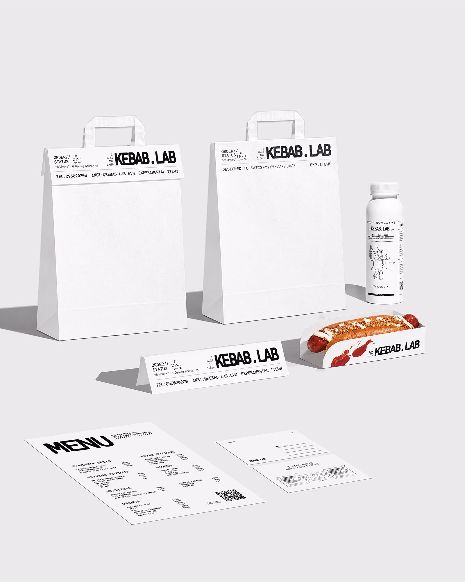 White carry-out bags and a beverage bottle feature bold black typography for Kebab.Lab’s brand identity and menu design.